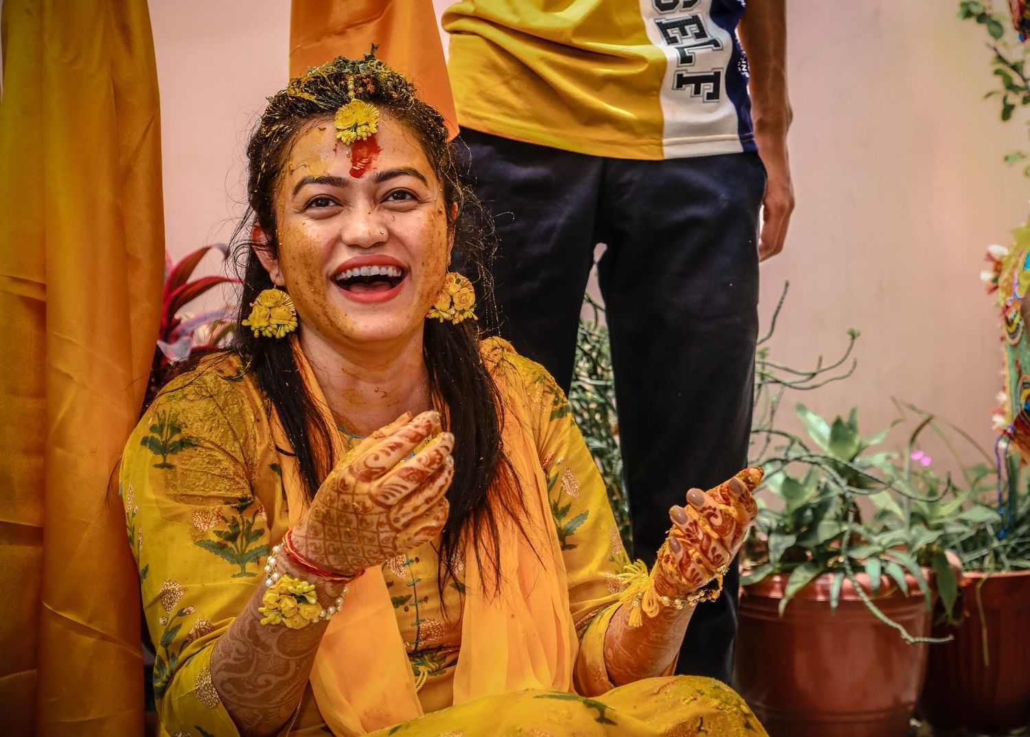 Traditional Indian celebration with vibrant yellow outfits and festive decorations.