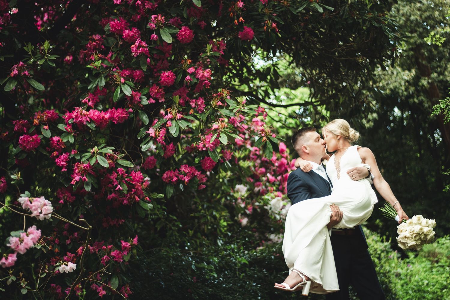 A series of romantic moments captured in a garden setting with pink bougainvillea flowers blooming in the background.