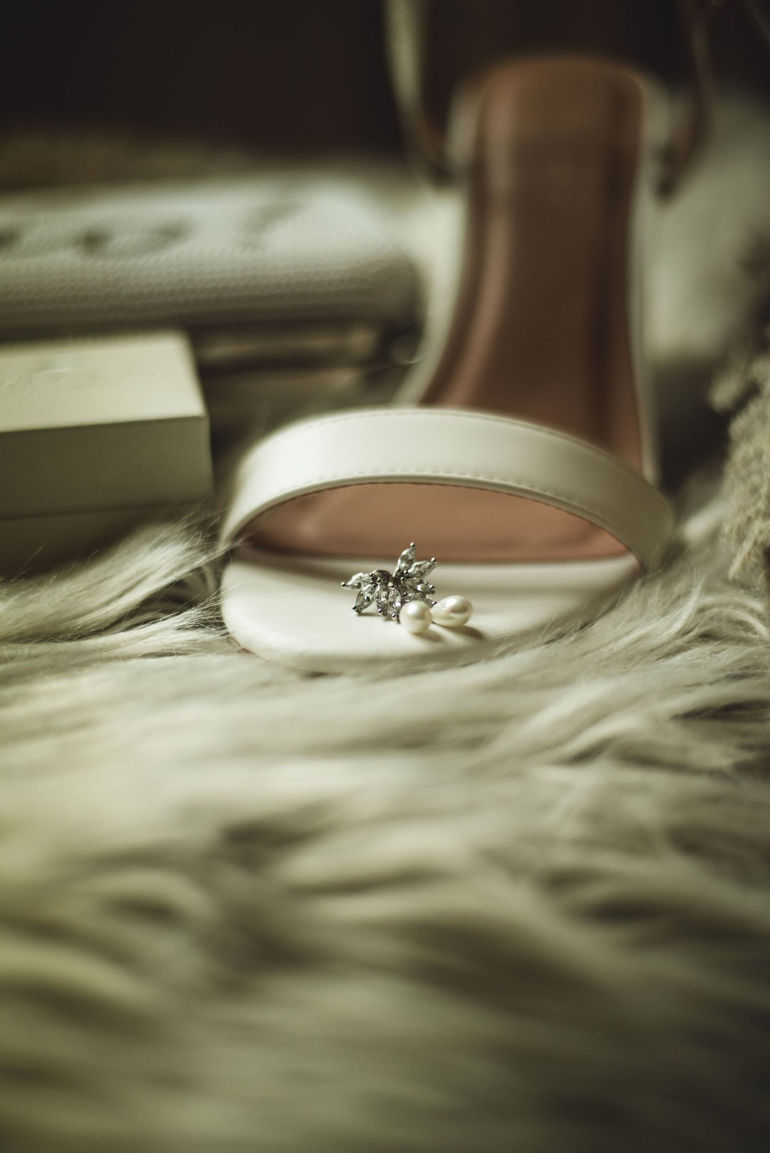 Close-up artistic shot of an engagement ring on a textured surface.