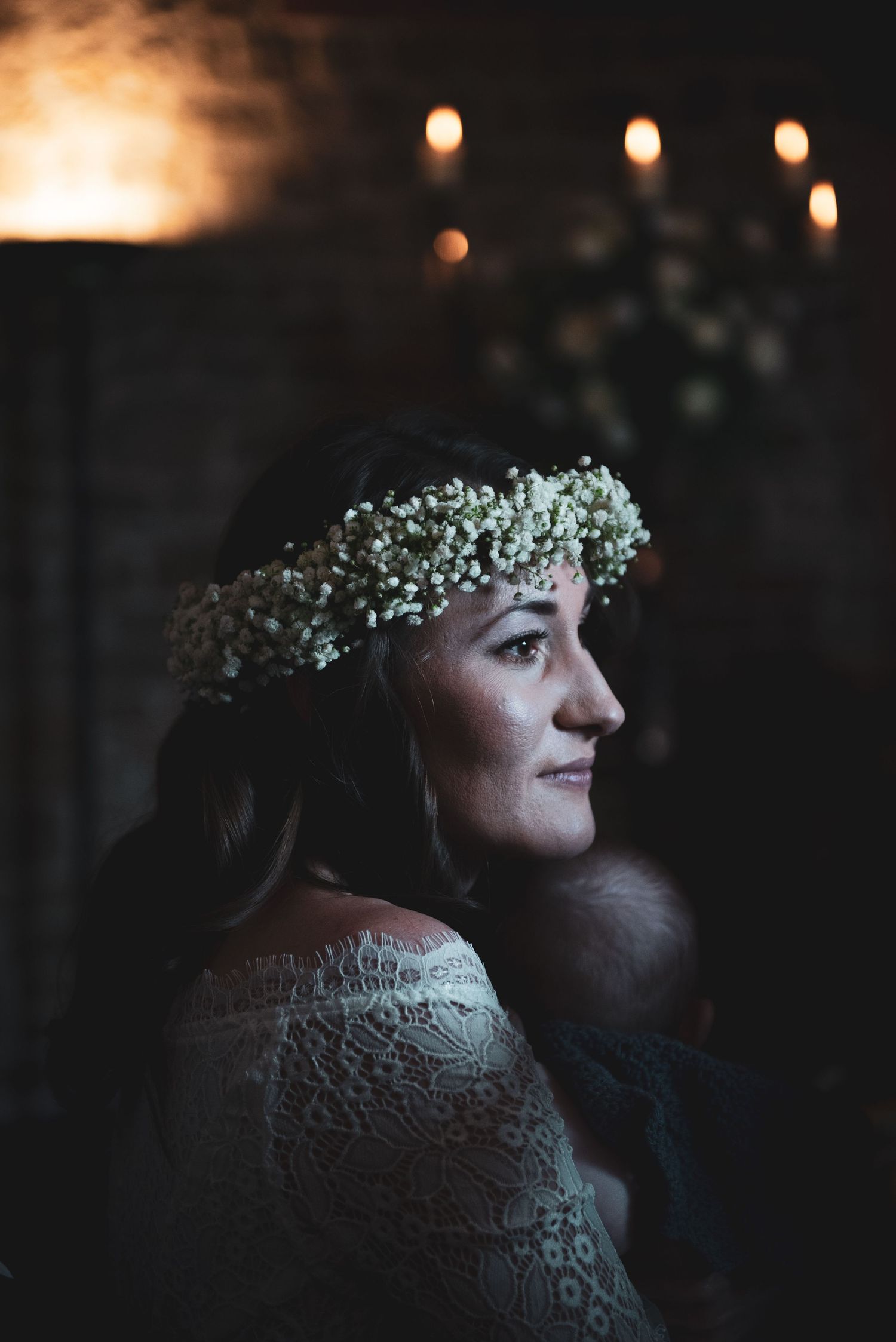 A dreamy wedding portrait with candlelit ambiance and delicate baby's breath flower crown.