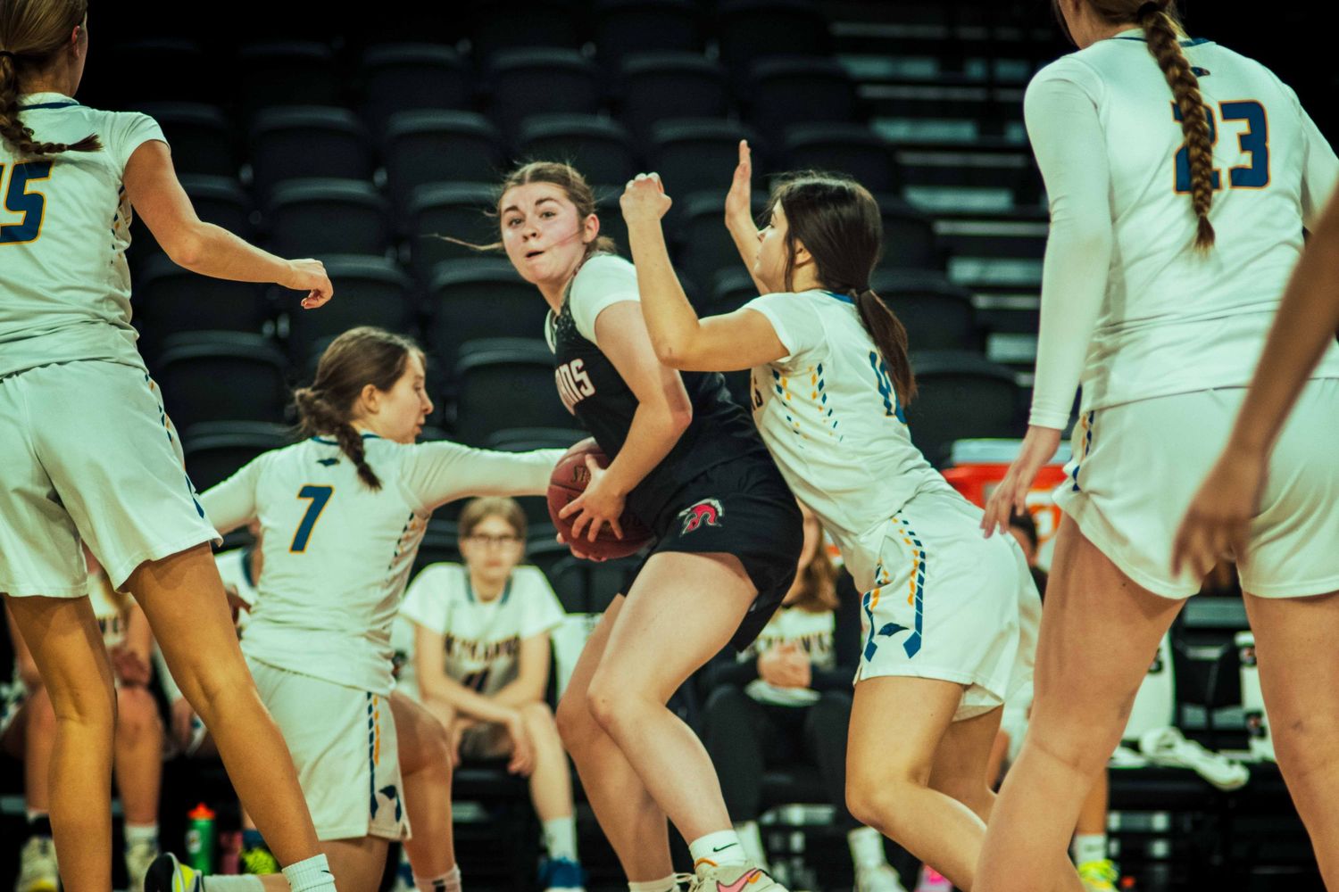Competitive volleyball match showing players in action on the court.