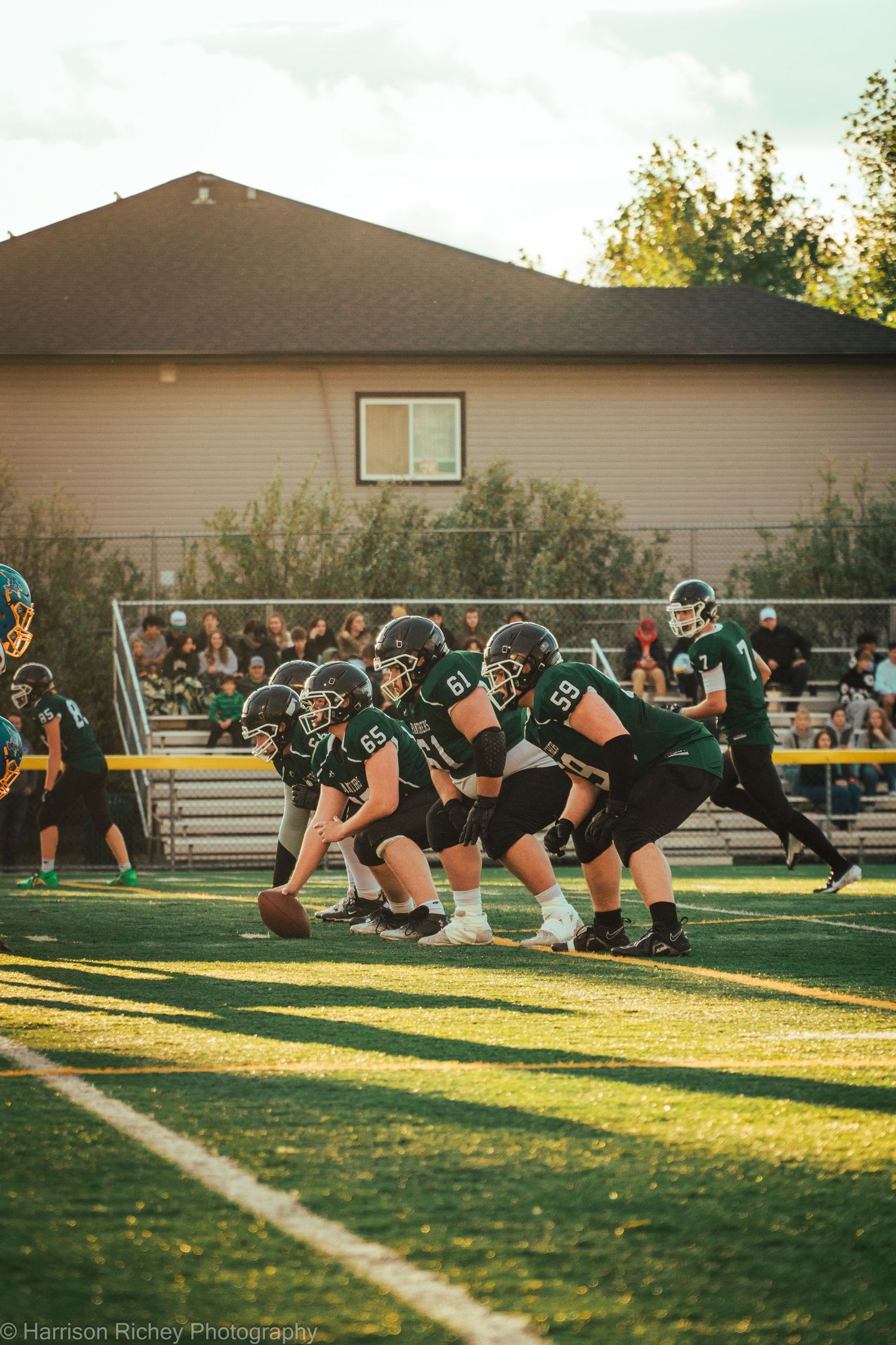 A series of motion frames showing football players initiating a play