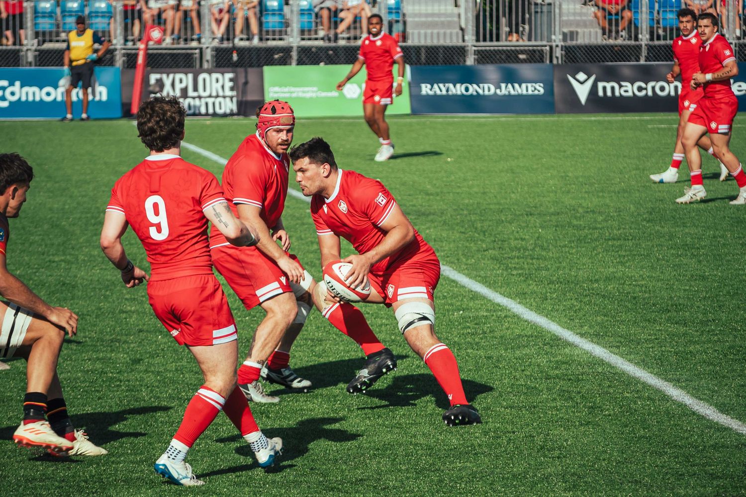 Rugby players engage in a dynamic ground play during a competitive match.