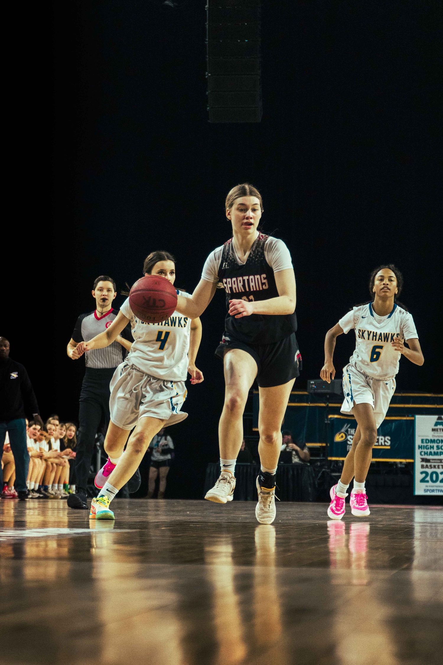 Basketball players battle for position during fast-paced game action on the court.