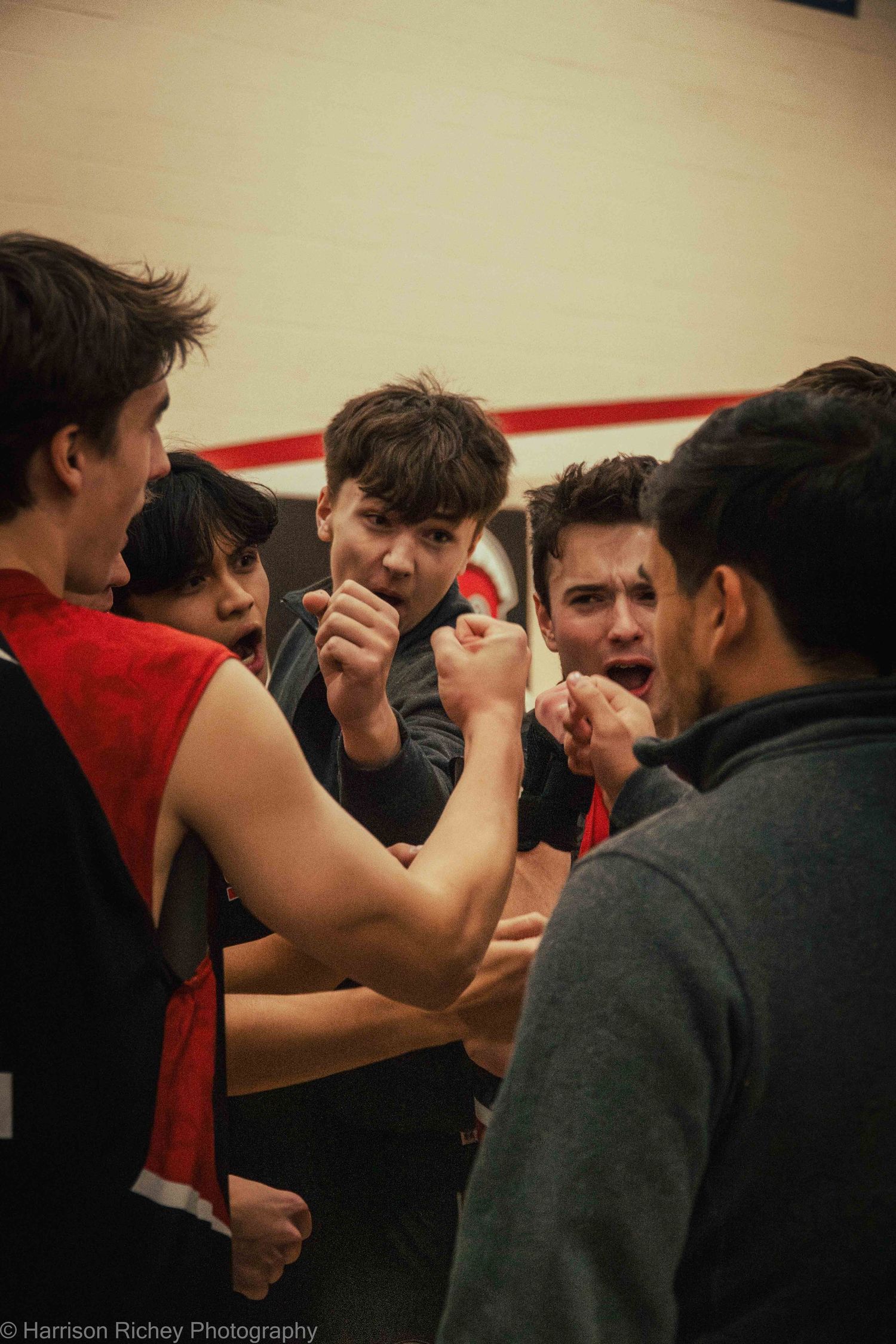 Team members engage in a competitive arm wrestling match during a break.