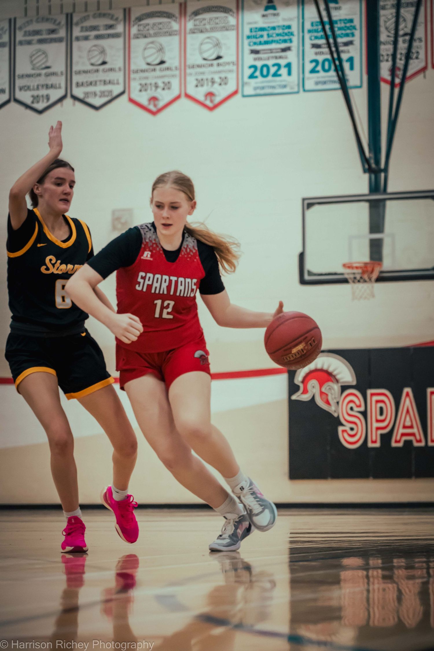 Basketball players in motion during an intense indoor game.