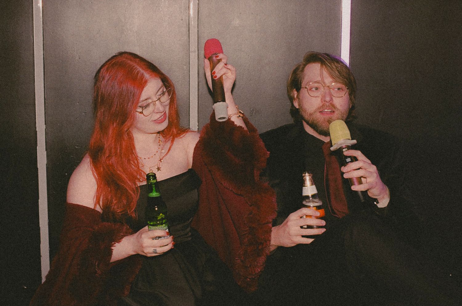 Friends enjoying drinks and conversation in a dimly lit bar setting.