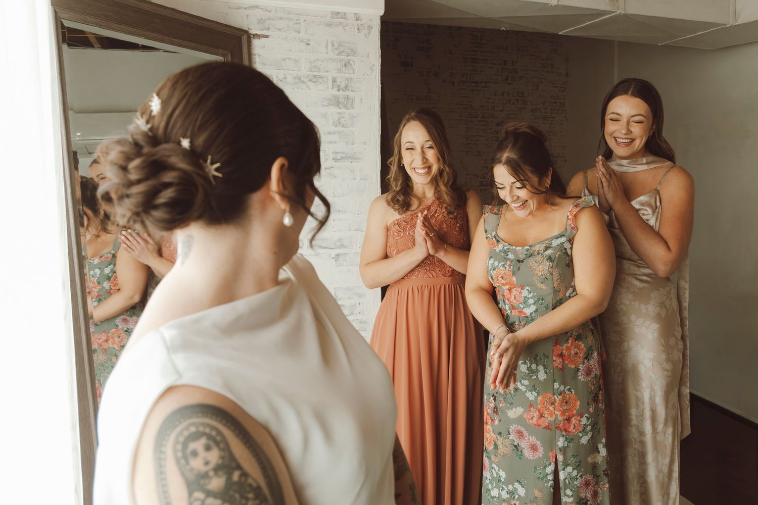 A group getting ready in a room with exposed brick walls.