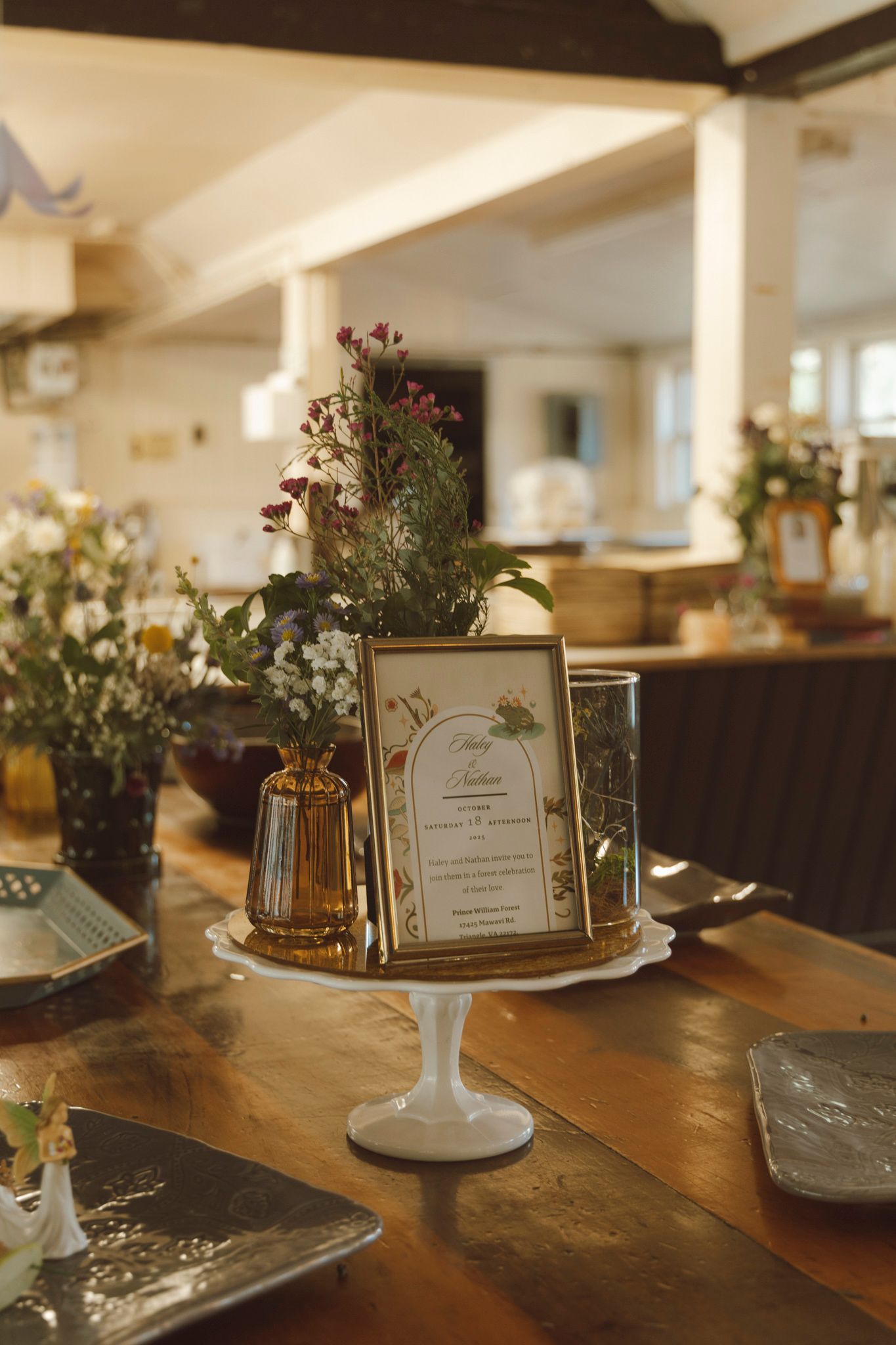 Elegant table settings with menu cards and floral centerpieces arranged on rustic wooden tables in a warmly lit dining room.