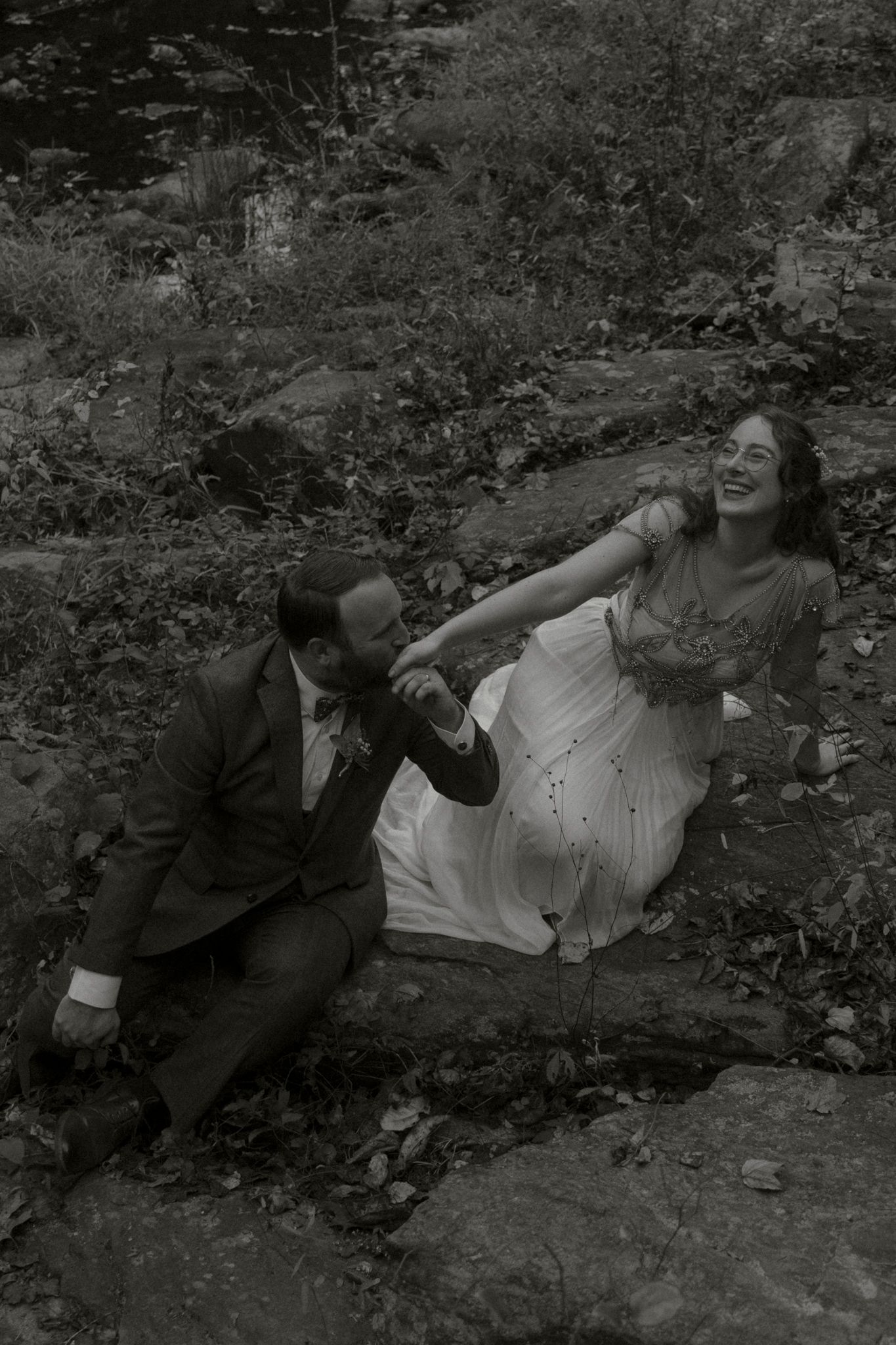 A sequence of black and white photos shows a person reclining on the ground in a natural outdoor setting.