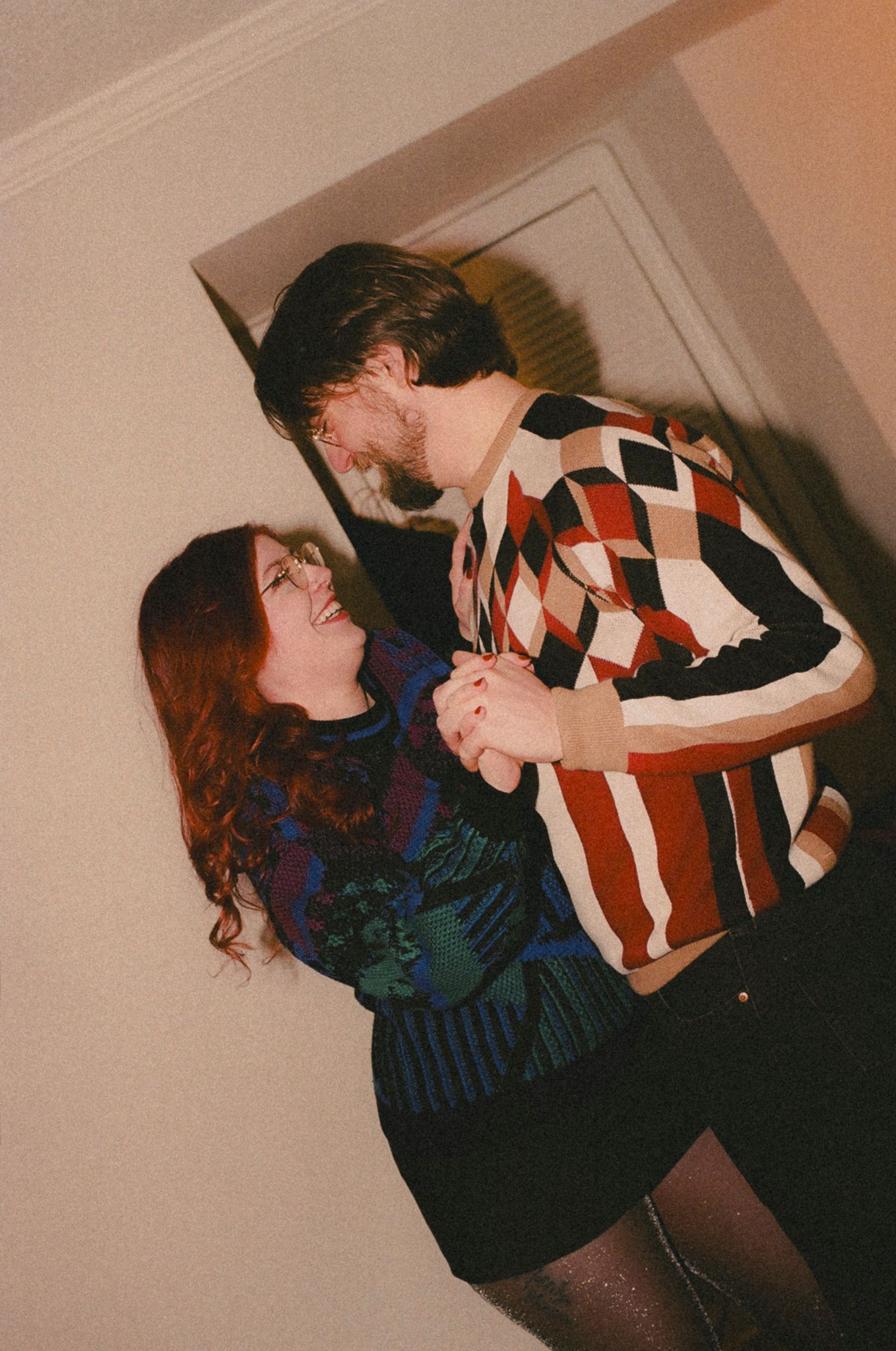 A sequence of vintage-style photos showing two people dancing and embracing in dramatic poses against a wall.