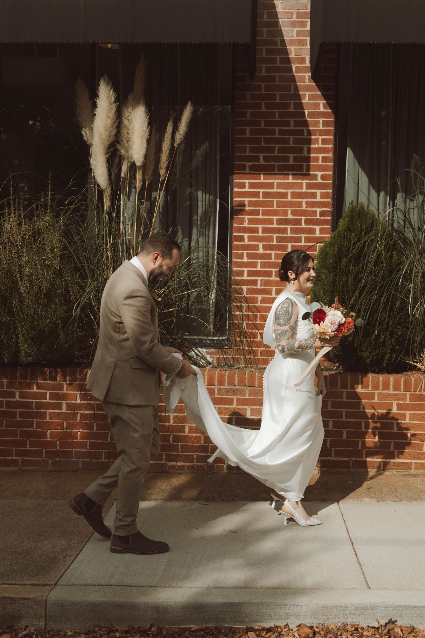A sequence of photos showing a groom helping adjust a bride's wedding dress train on a brick sidewalk.