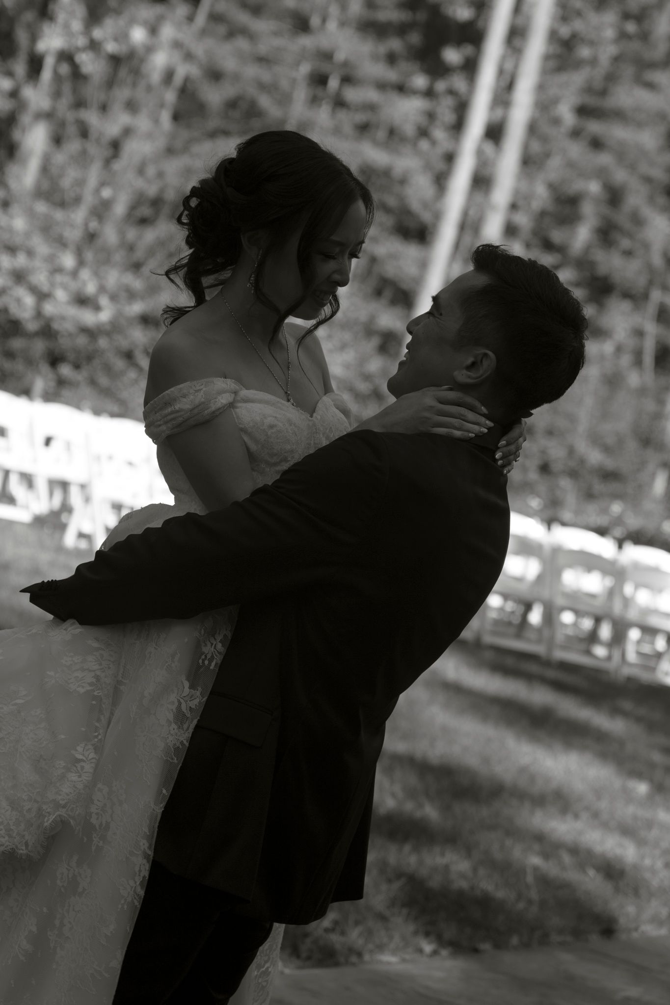 Romantic black and white photo series capturing a couple's intimate embrace at their wedding celebration.