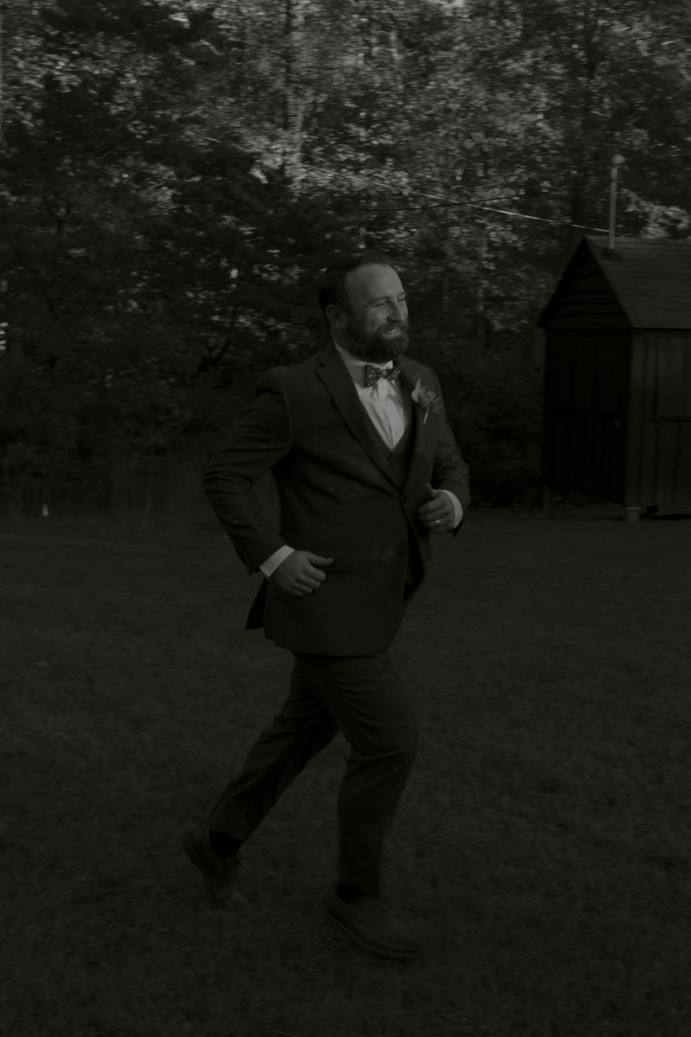 A sequence of black and white photos shows a person in a suit performing dance moves outdoors.