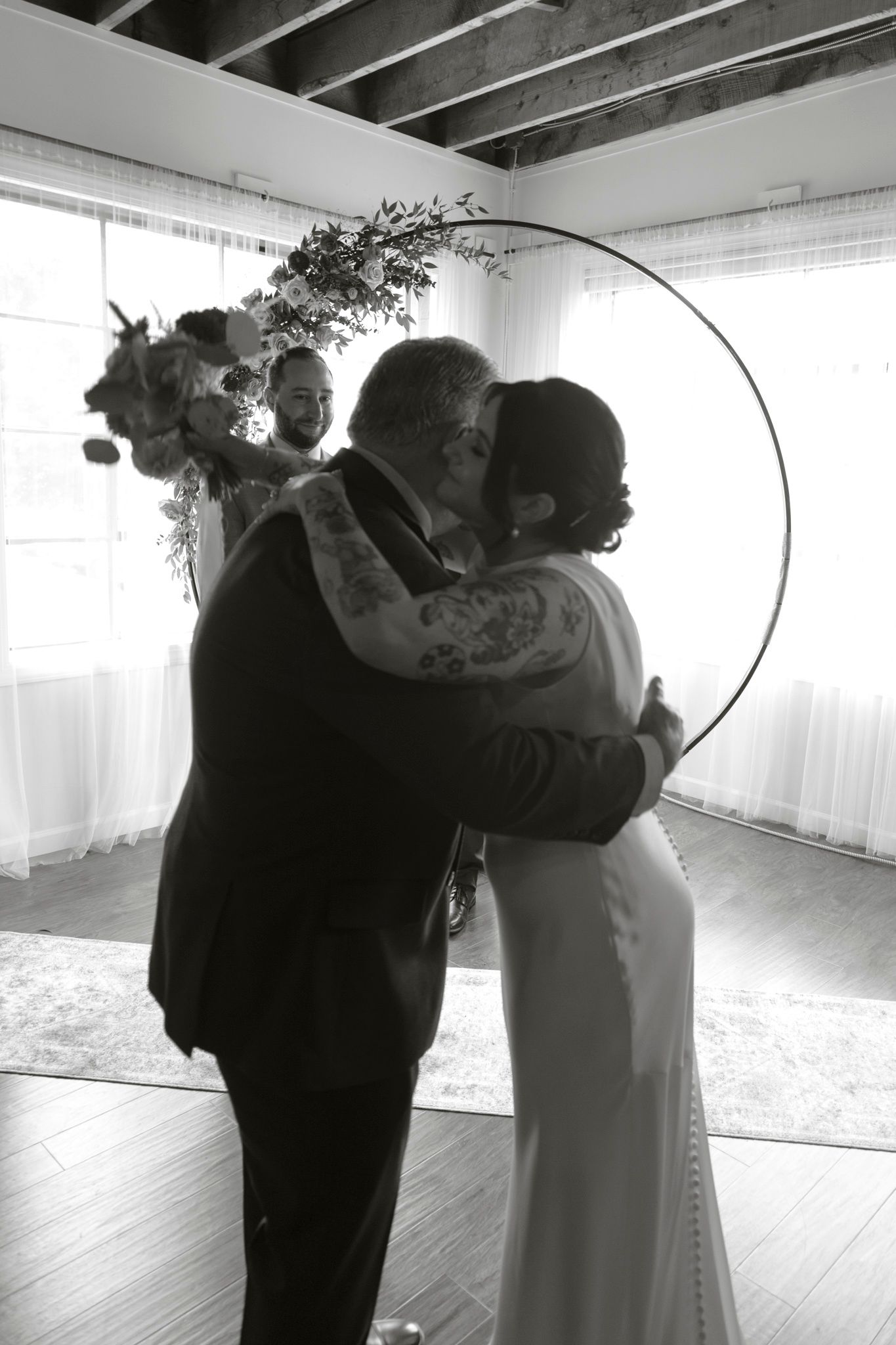 A sequence of black and white photos showing a couple dancing in a romantic moment at their wedding.