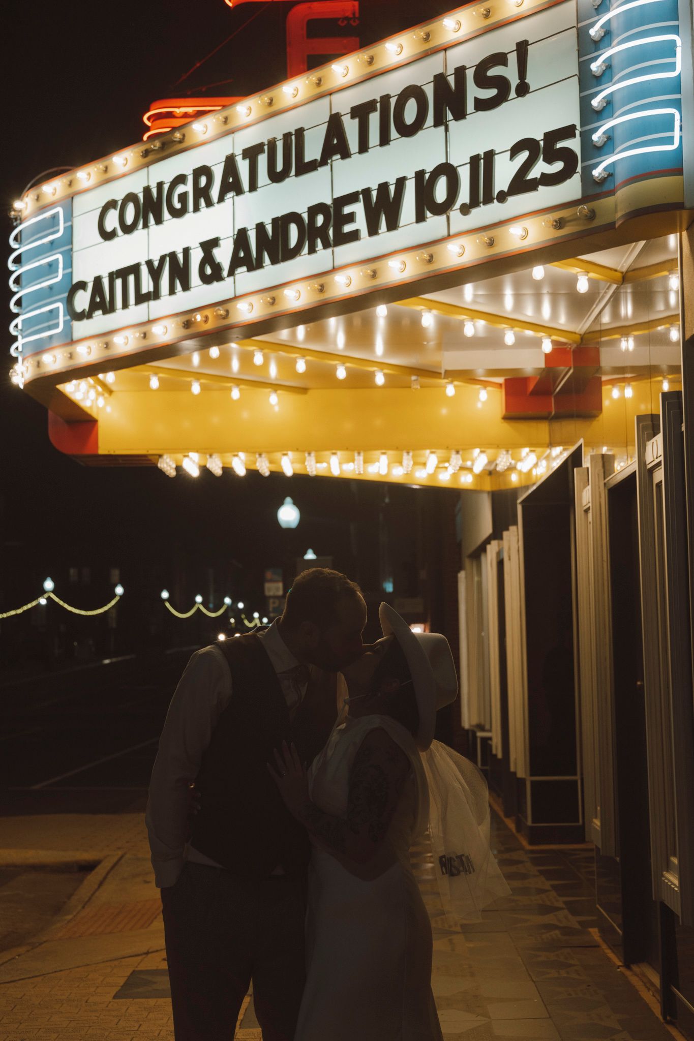 A marquee sign with illuminated letters displaying 'CONGRATULATIONS!' against a dark night sky.