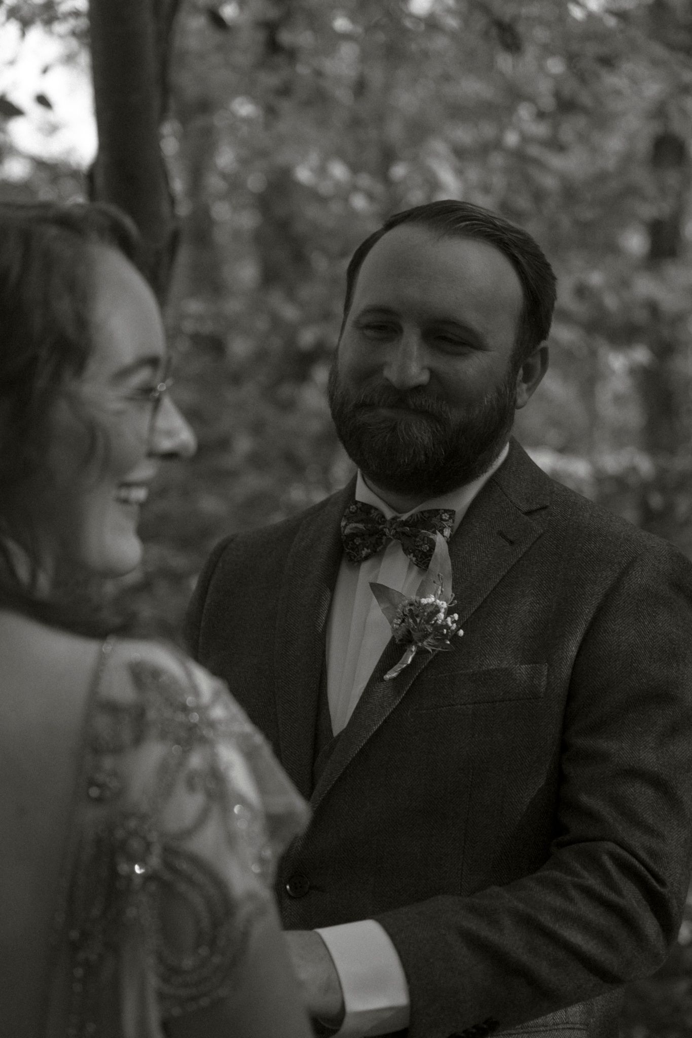 Black and white wedding photos show emotional reactions during a ceremony.