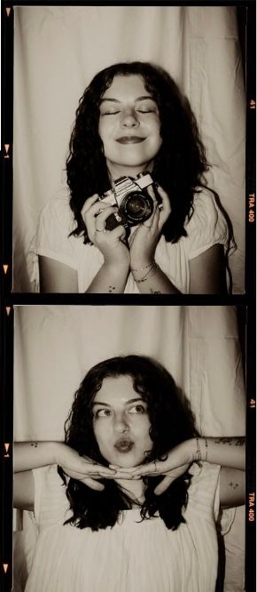 Young woman with curly dark hair holds a vintage film camera, smiling with eyes closed in a black and white photo strip.