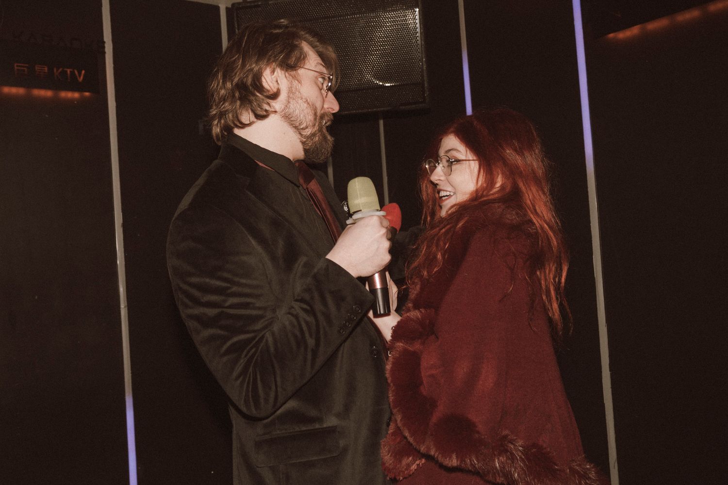 A couple shares an intimate moment together while dancing in formal attire at an evening event.