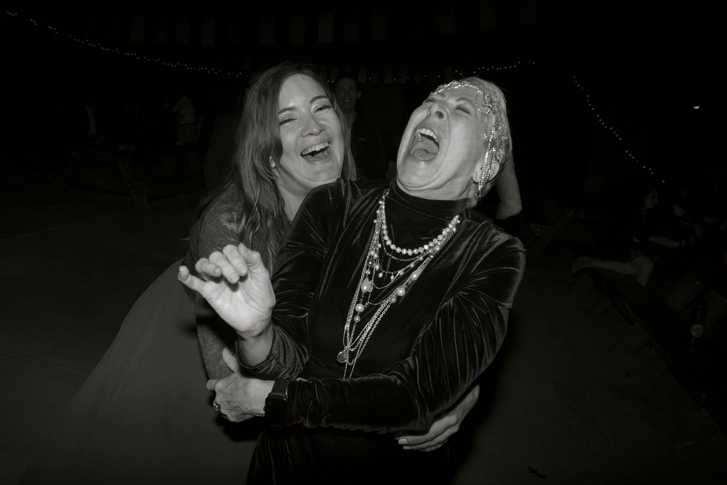 A series of black and white photographs showing people laughing and expressing joy in candid moments.