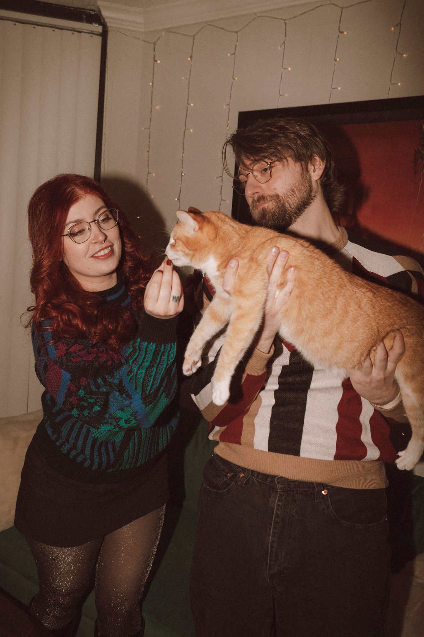 A sequence of photos showing a person in a striped sweater interacting playfully with an orange cat.