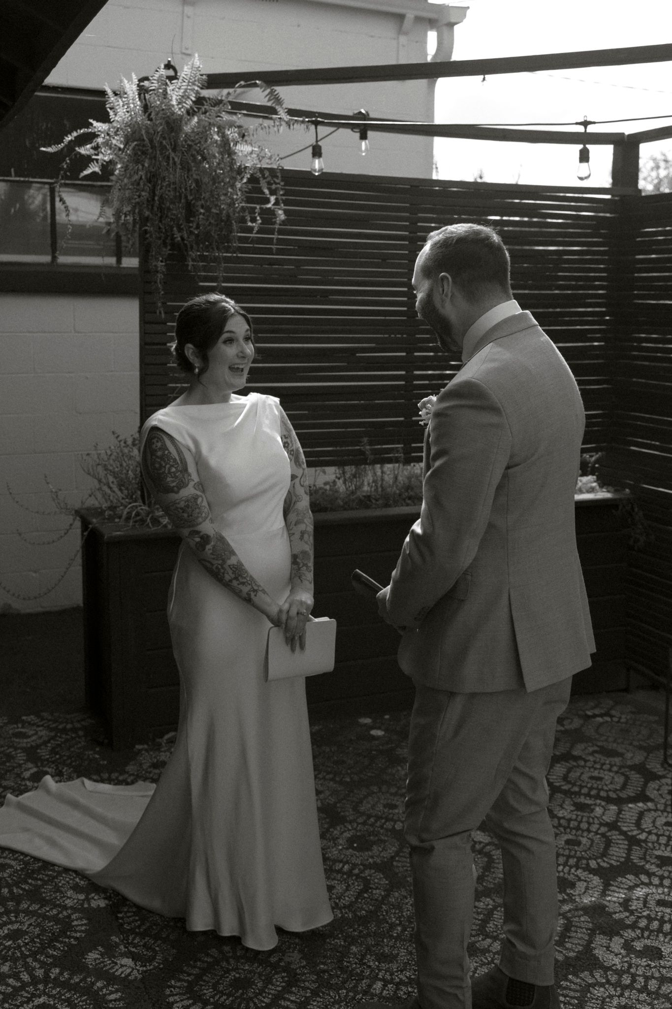 Black and white sequence of newlyweds dancing together on a rooftop.