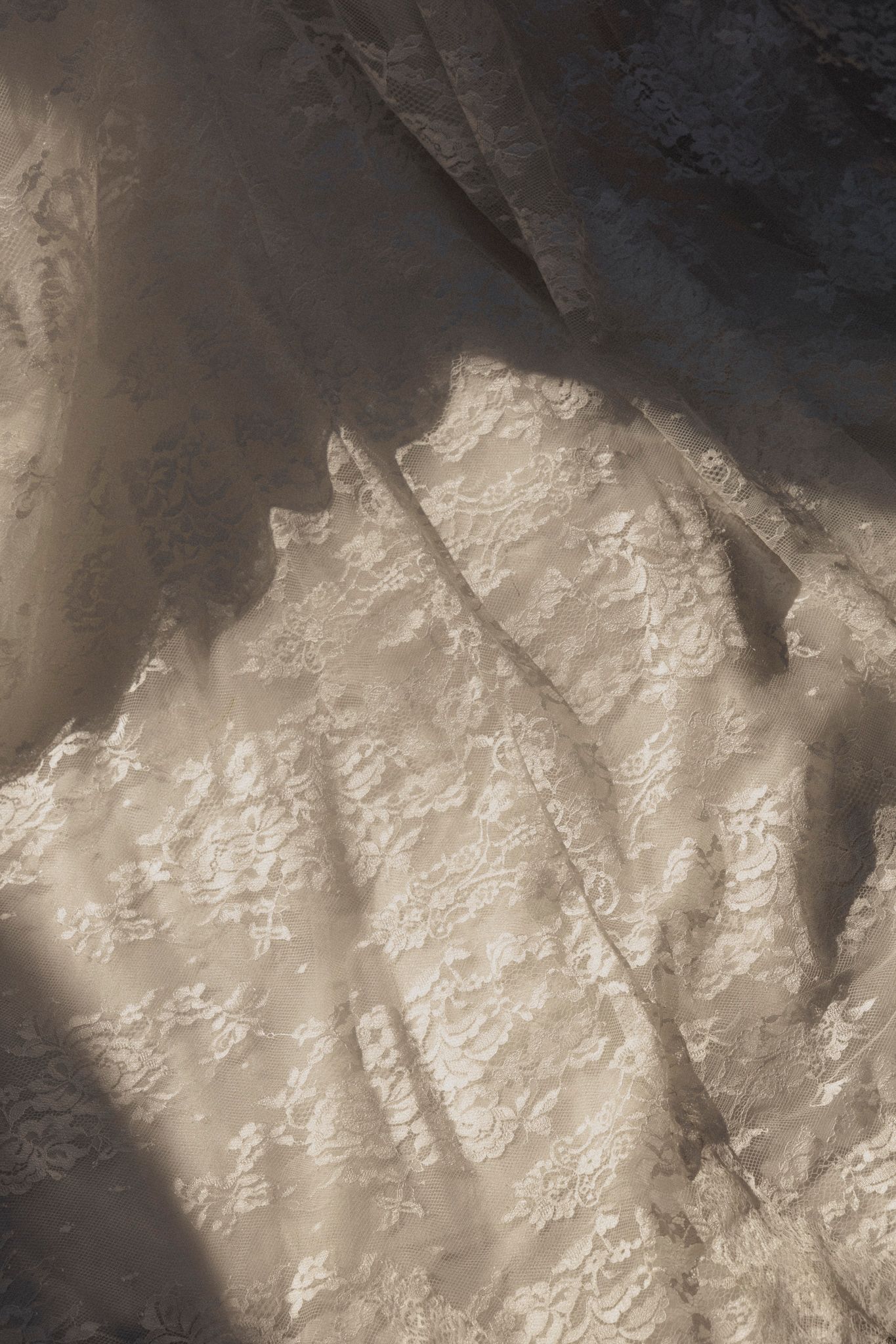 Close-up view of rough textured white limestone rock surface with natural patterns and shadows.