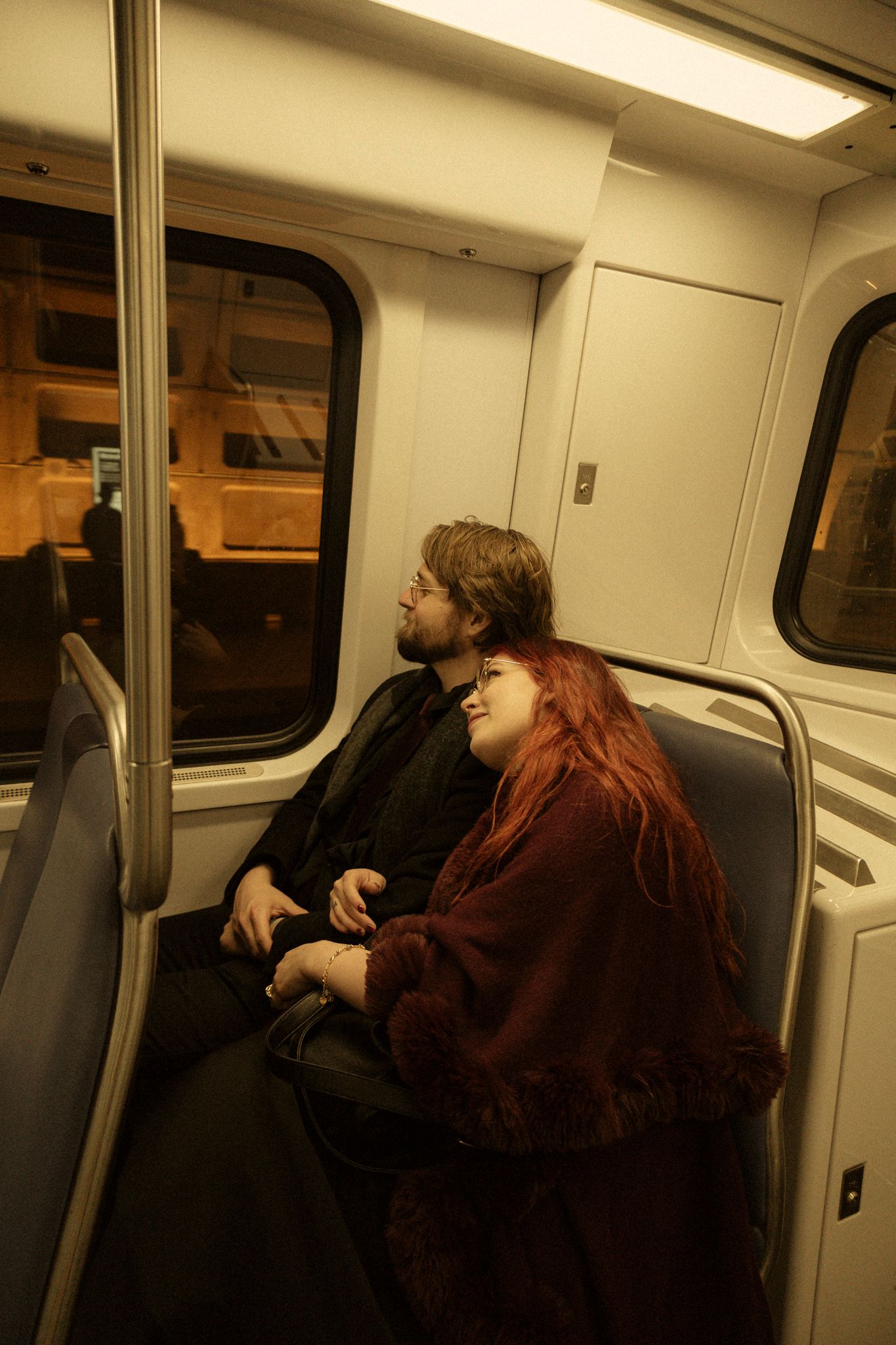 A sequence of photos shows passengers looking out the window while riding on a train or subway car.