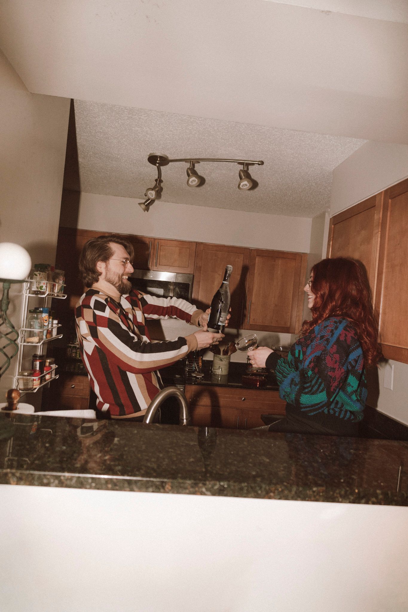Four sequential photos show someone performing a backflip on a kitchen counter with marble countertops.