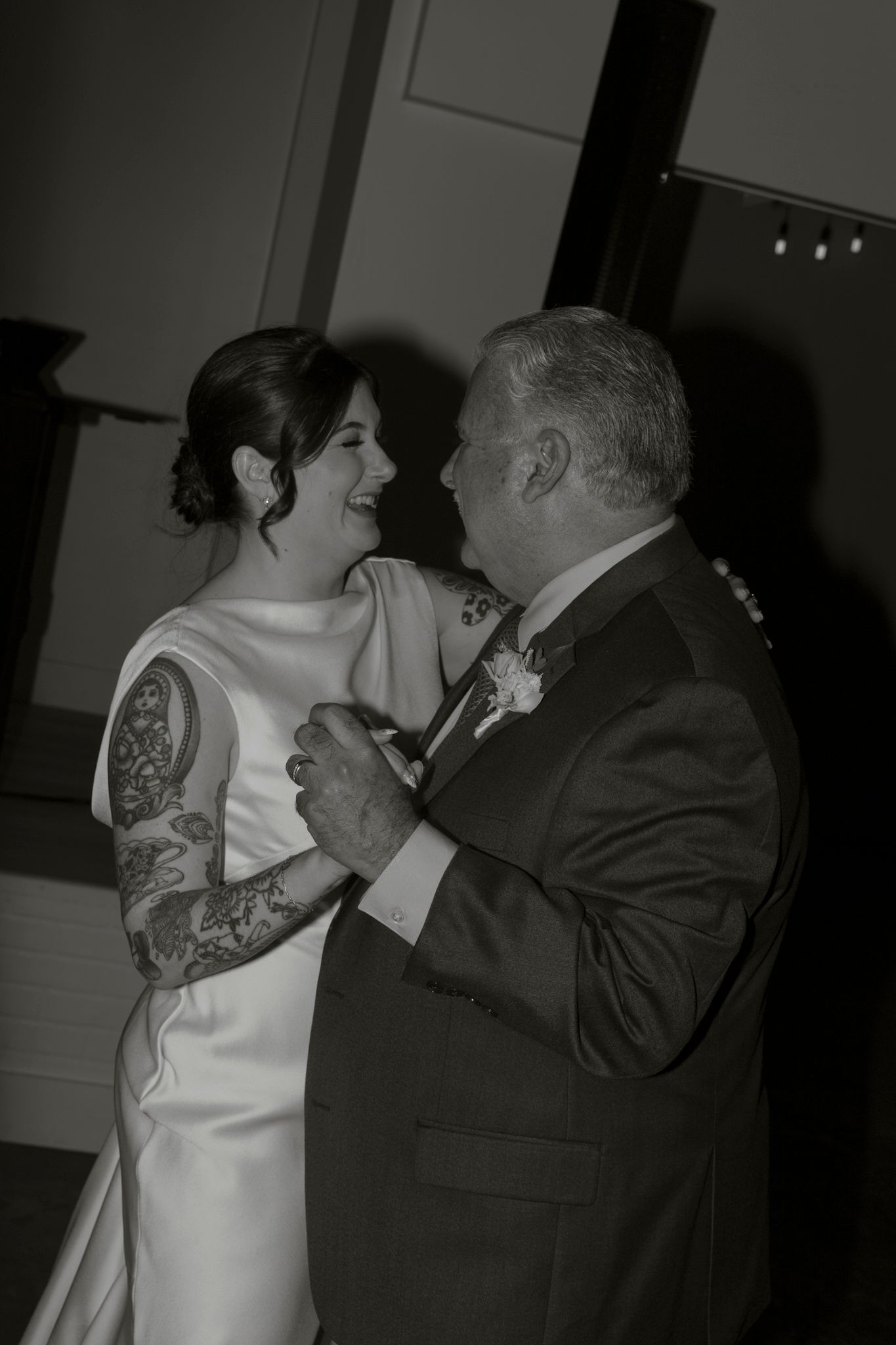 A series of black and white photos showing a couple dancing together at what appears to be a wedding reception.