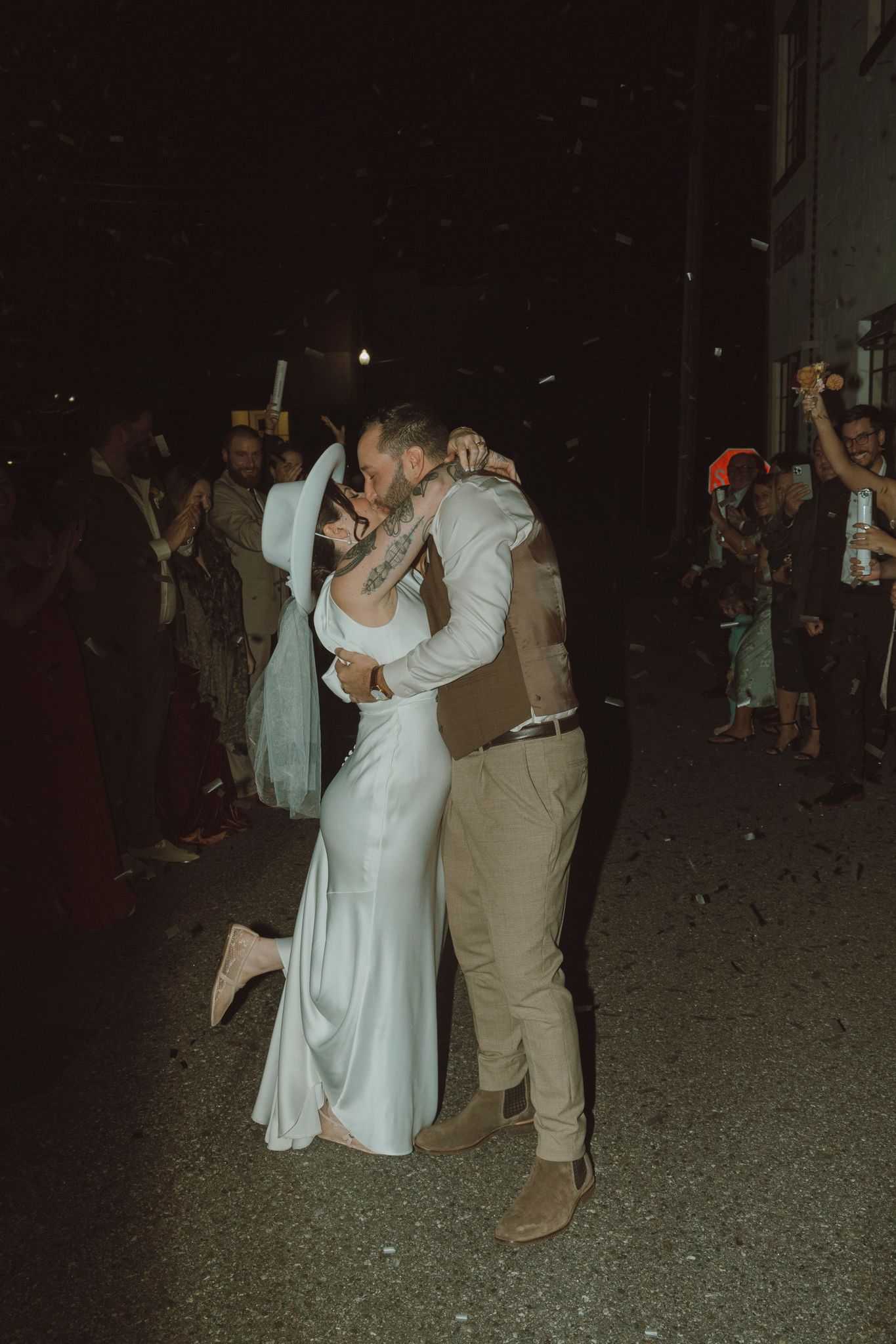 A couple shares a romantic dance moment under the night sky at their celebration.