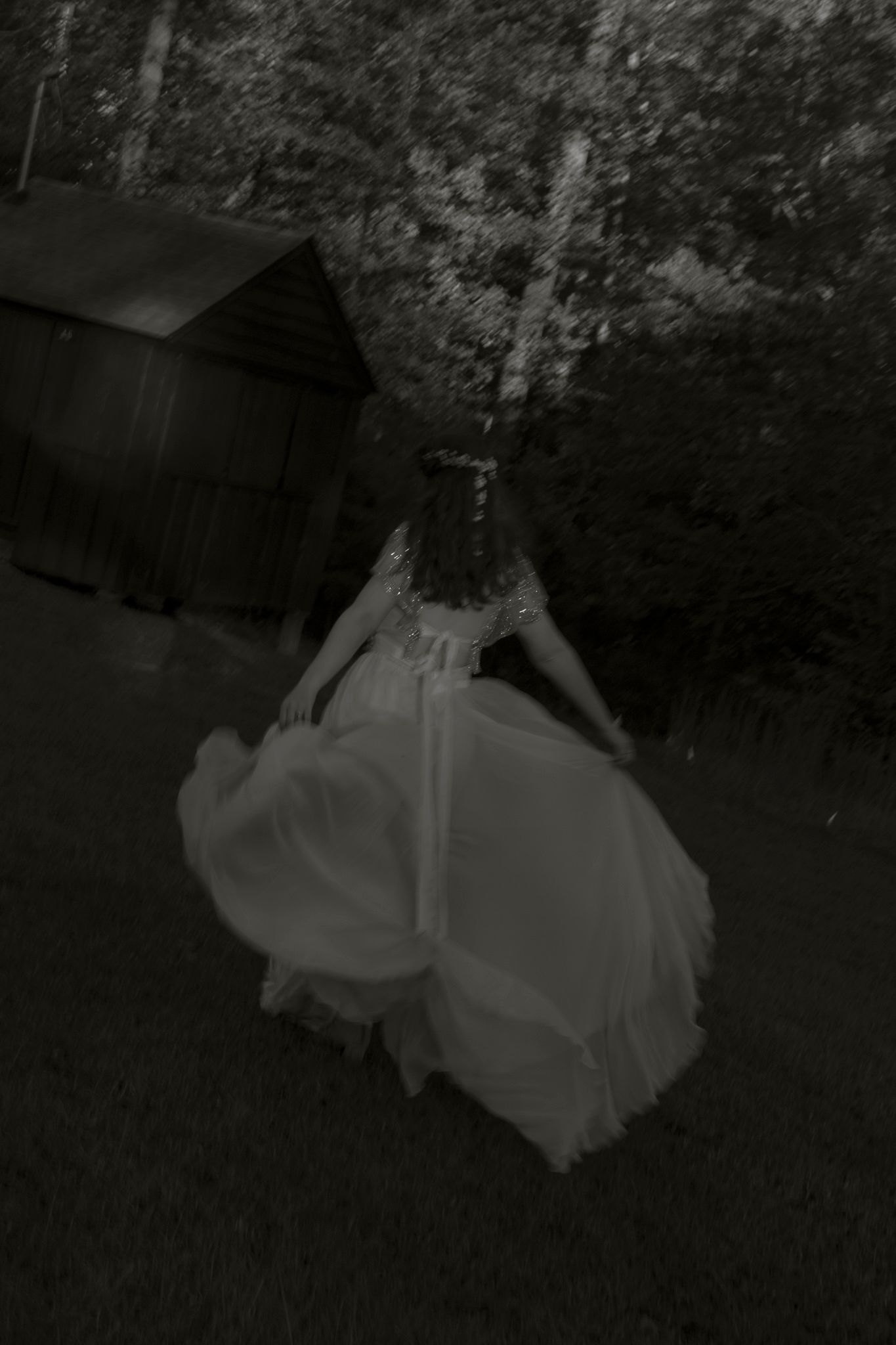 A black and white photo sequence showing a flowing white dress twirling in motion against a dark background.