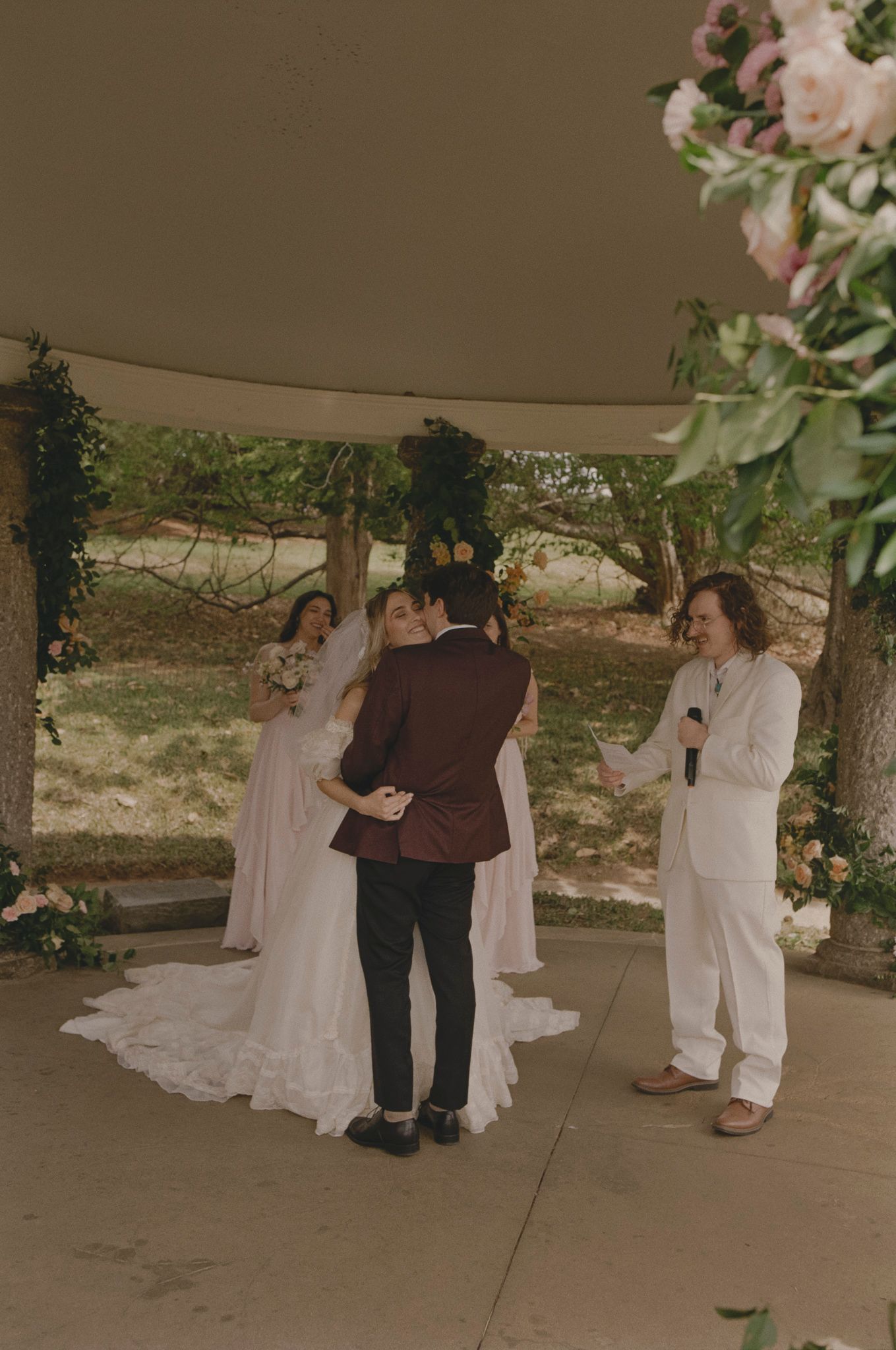 A sequence of four candid dance photos showing couples dancing together at an outdoor covered venue.