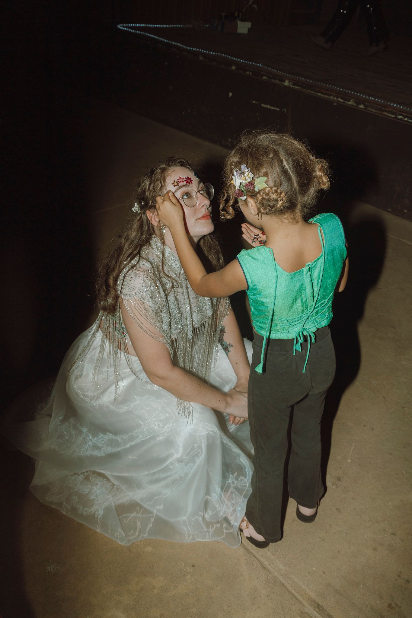 Two people in costume makeup interact at what appears to be a Halloween or costume party.