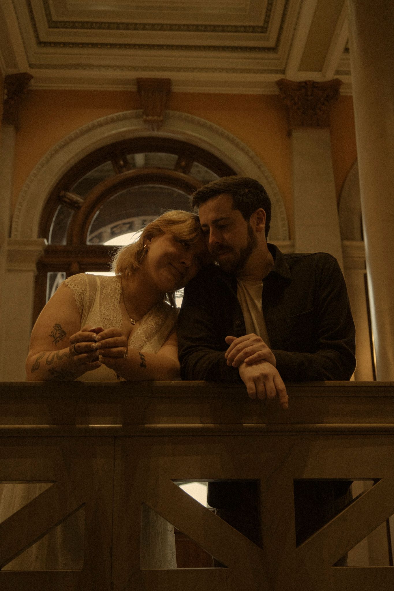 A romantic couple shares an intimate moment in a dimly lit train car interior.