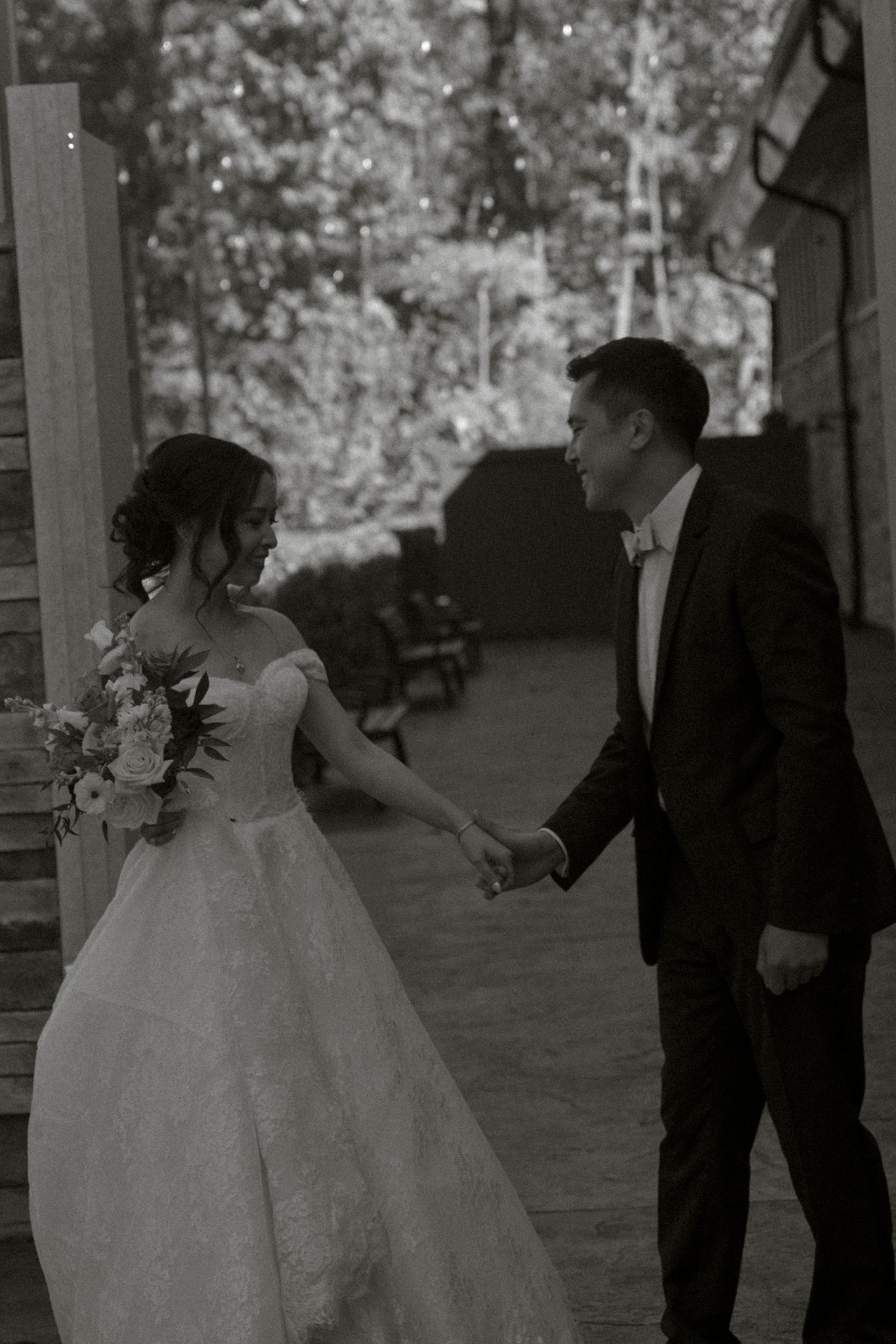 A bride and groom share a romantic dance sequence during their wedding reception on an outdoor patio.