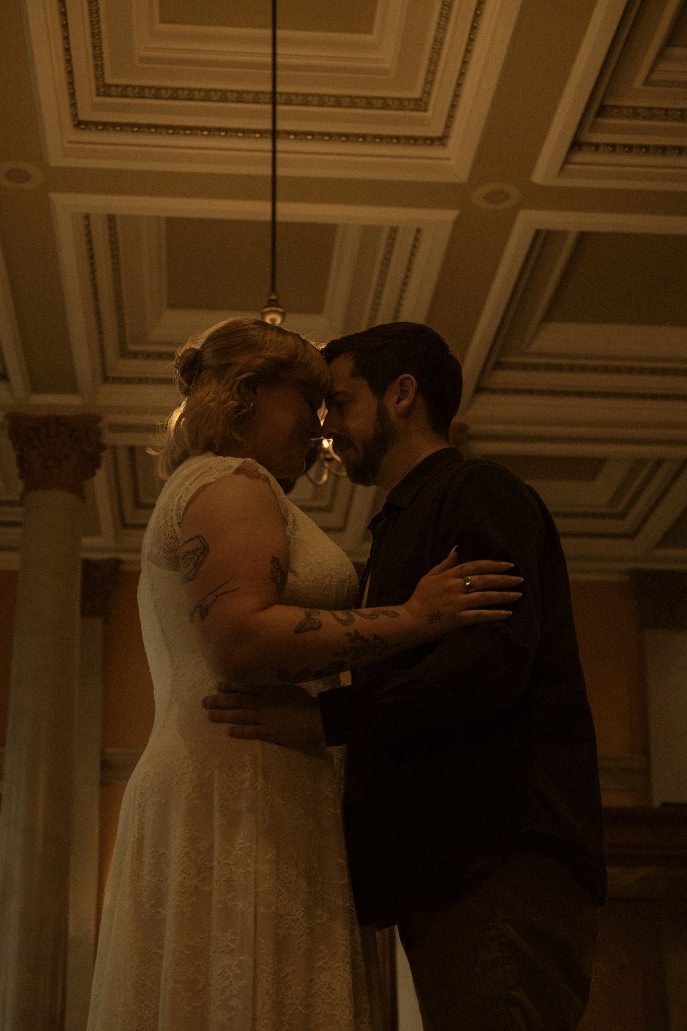 A romantic wedding kiss sequence showing a couple sharing their first kiss as newlyweds in an elegant venue.