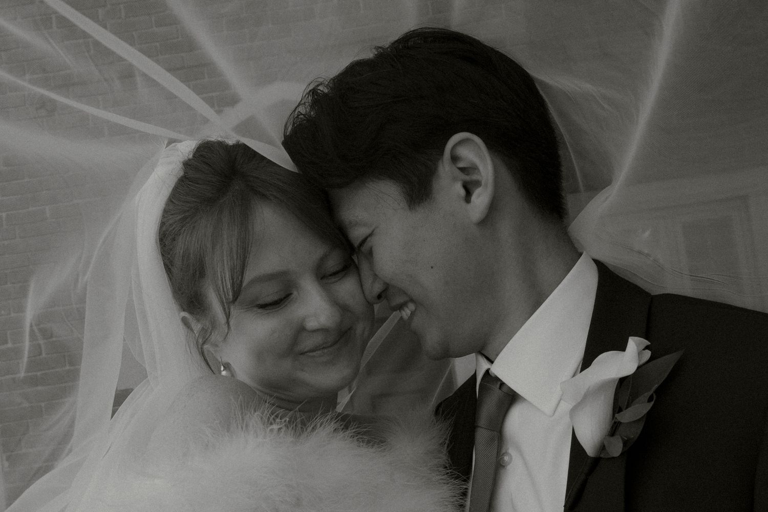 A series of romantic black and white wedding photos showing tender moments between a bride and groom.