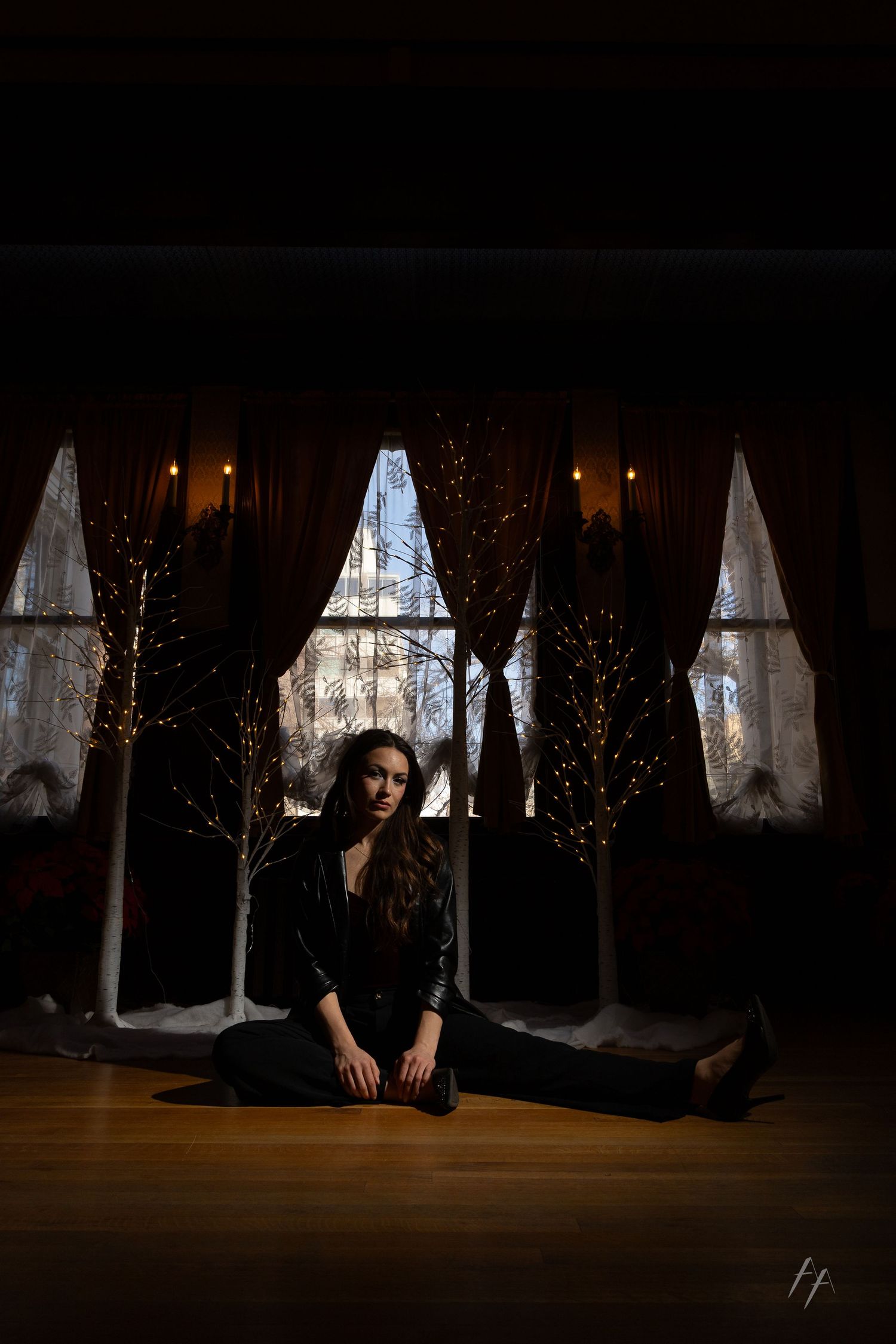 Dark artistic photos showing someone lying beneath curtains with dramatic window lighting and shadows.