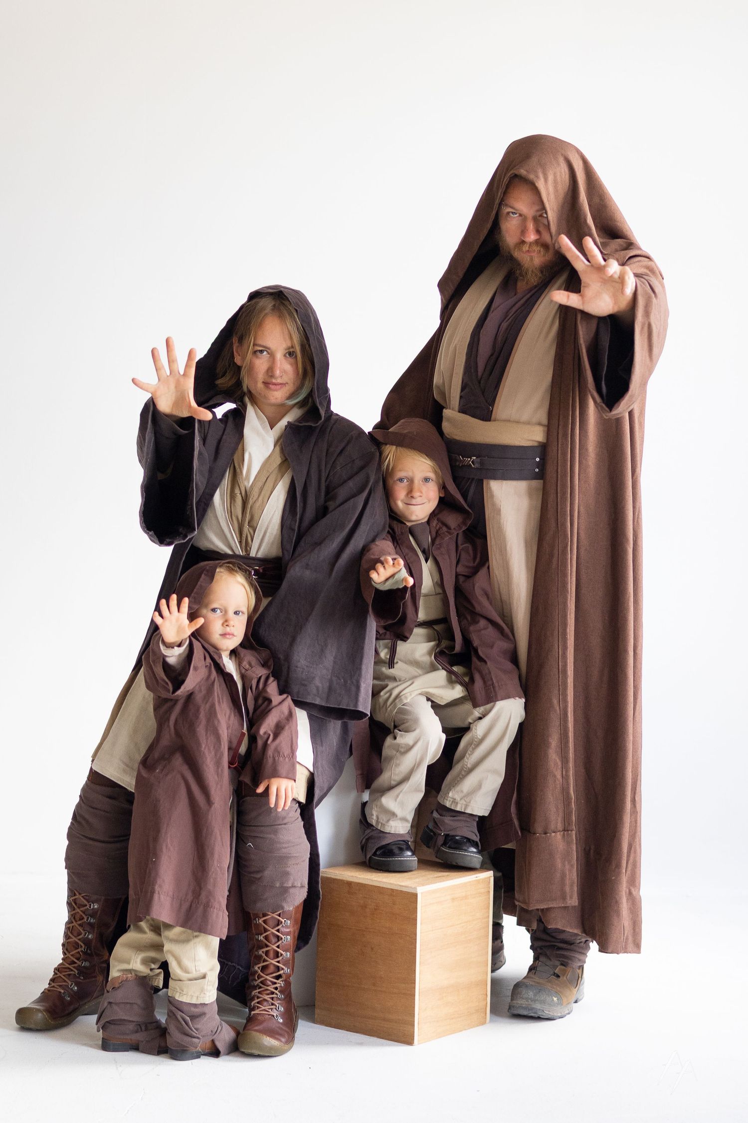 A series of playful poses showing someone in brown robes and boots sitting and gesturing on a wooden box.