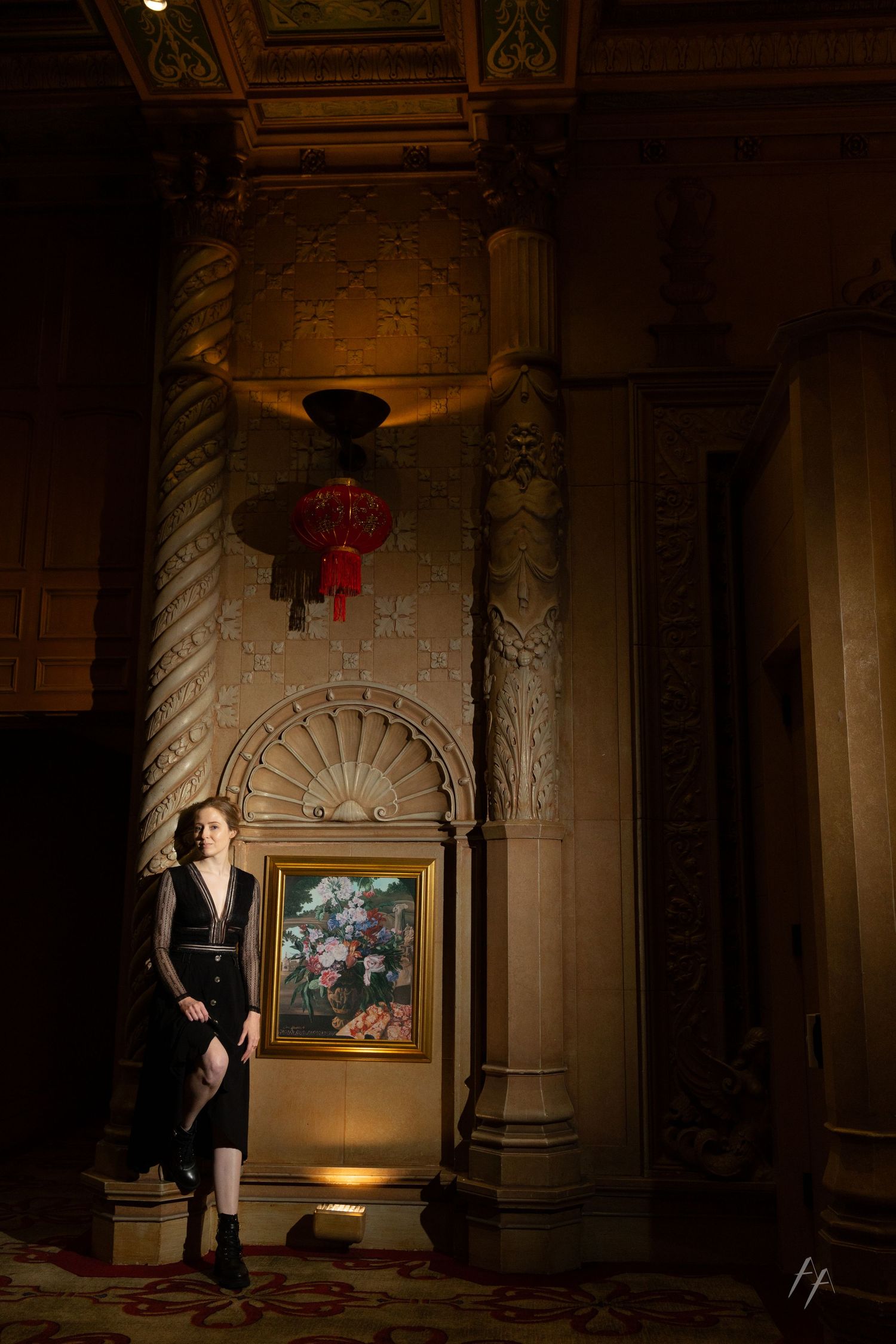 A series of dark, moody interior shots showing a figure in formal attire illuminated by dramatic lighting in an ornate hallway.