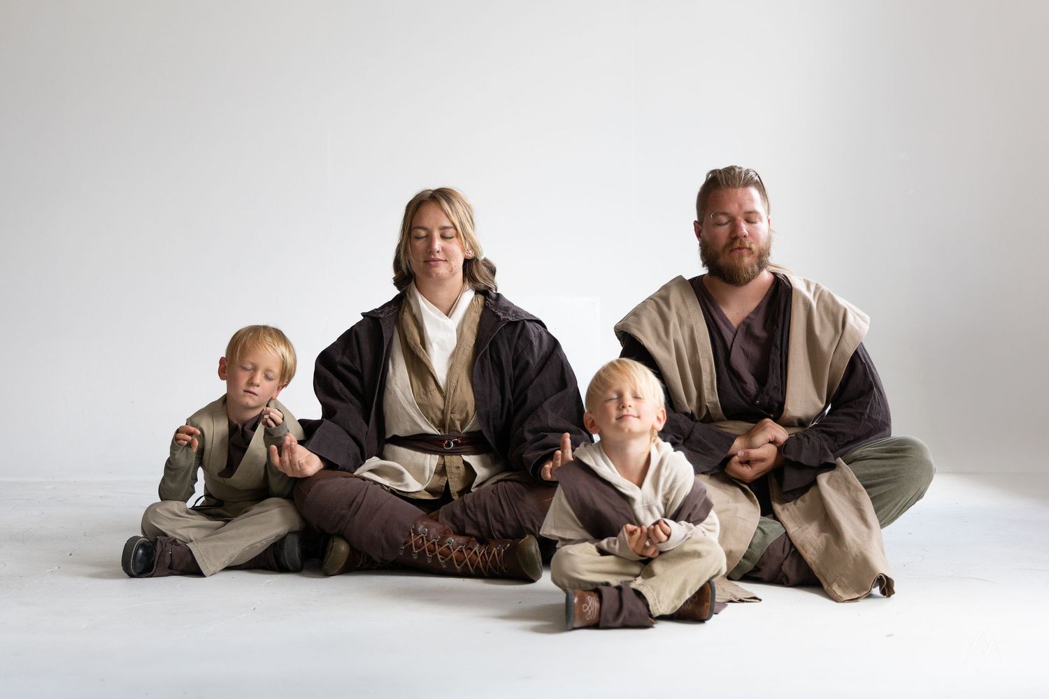 A series of heartwarming photos showing a parent and baby lying on white background in coordinating brown outfits.