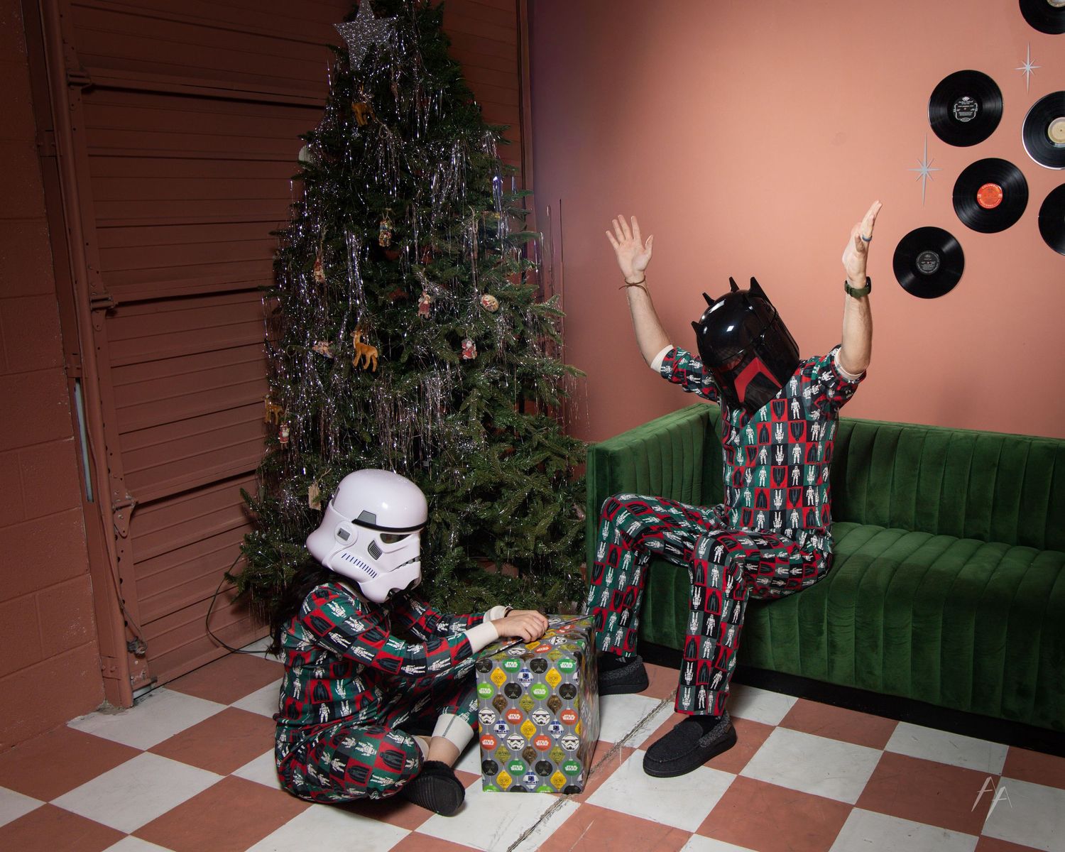 A sequence of holiday photos showing someone sitting on a green couch next to a decorated Christmas tree with Star Wars Helmets