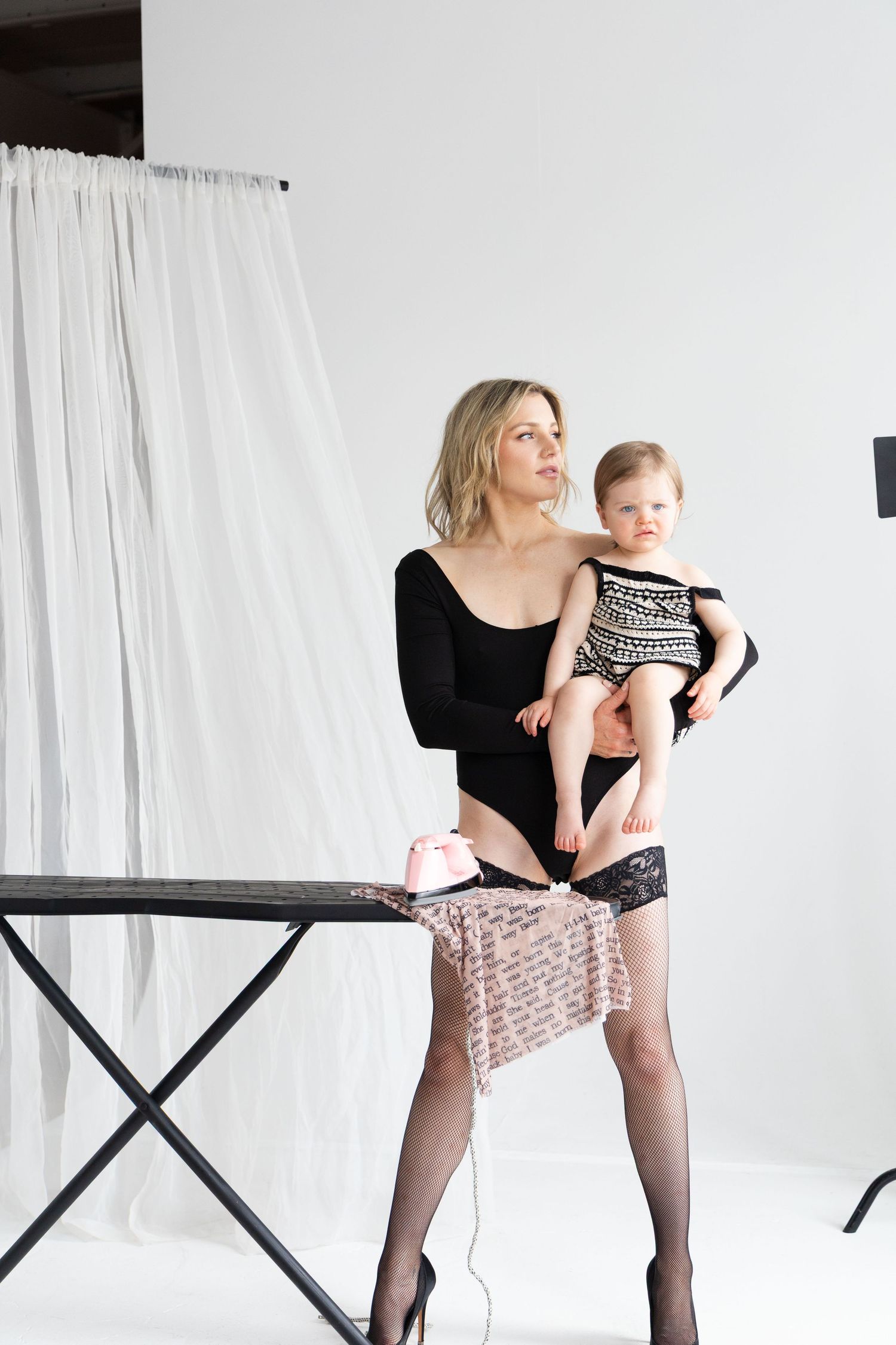 A series of black and white studio portraits showing tender moments between parent and child against a light background.