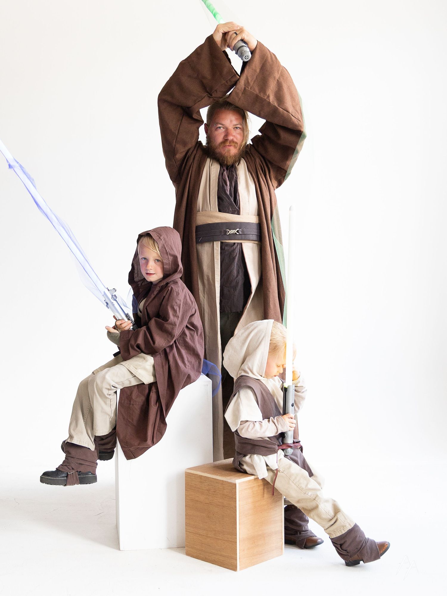 A Star Wars themed photo series showing a Jedi figure posing with a lightsaber in different seated positions on wooden boxes.