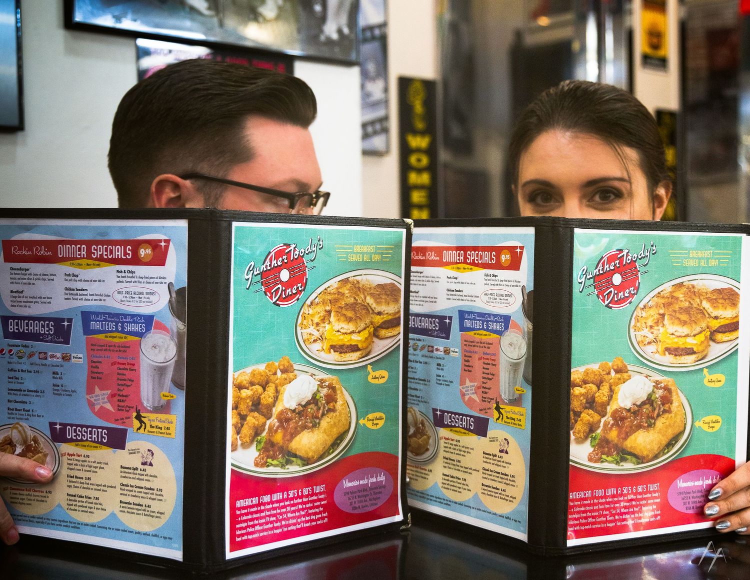 A row of frozen dinner boxes displayed on a store shelf showing various meal options and packaging designs.