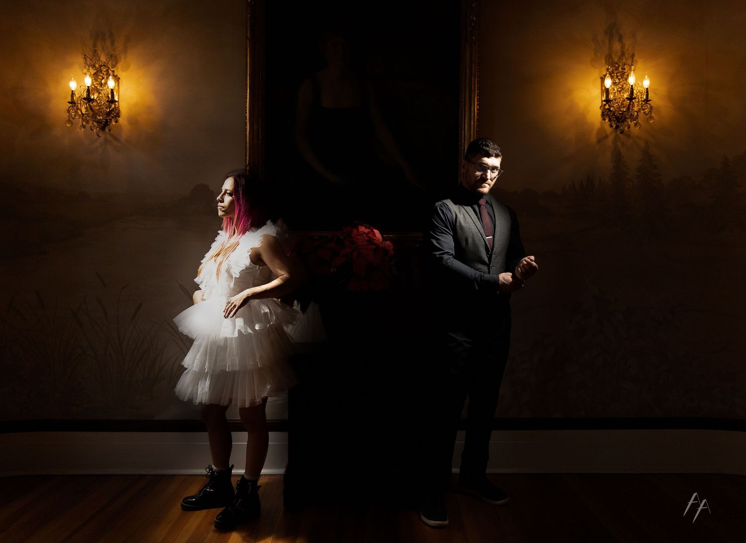 A sequence of dark moody photos showing figures in formal attire dancing and posing in an elegant room with chandeliers.