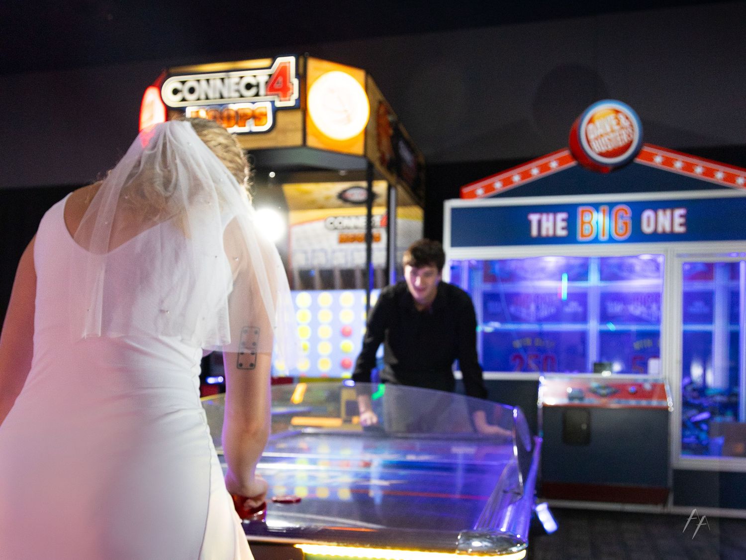 Colorful arcade interior with neon lights and gaming machines creating a vibrant atmosphere.