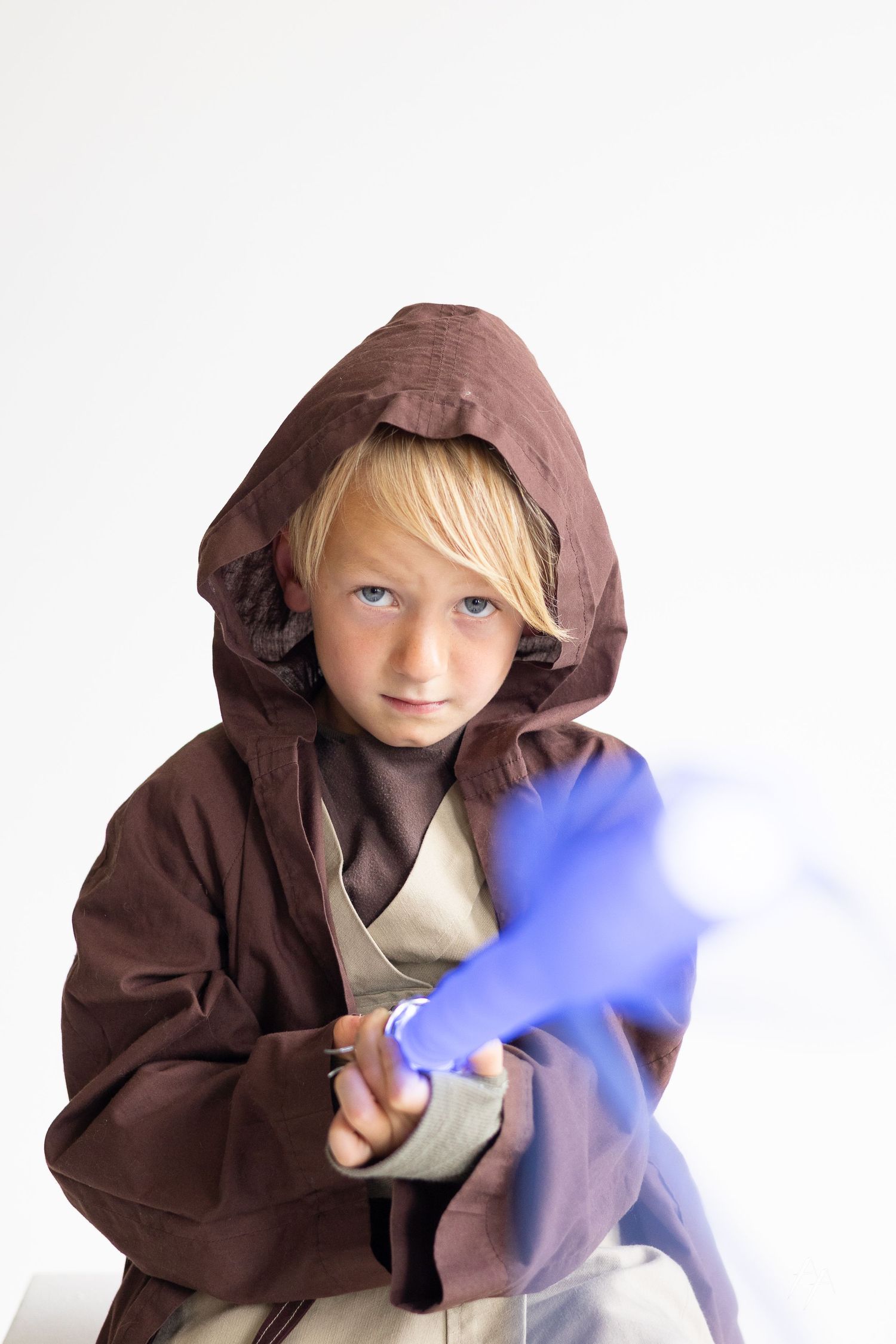 A figure in a brown hooded robe holds a glowing blue lightsaber in a sequence of action poses.