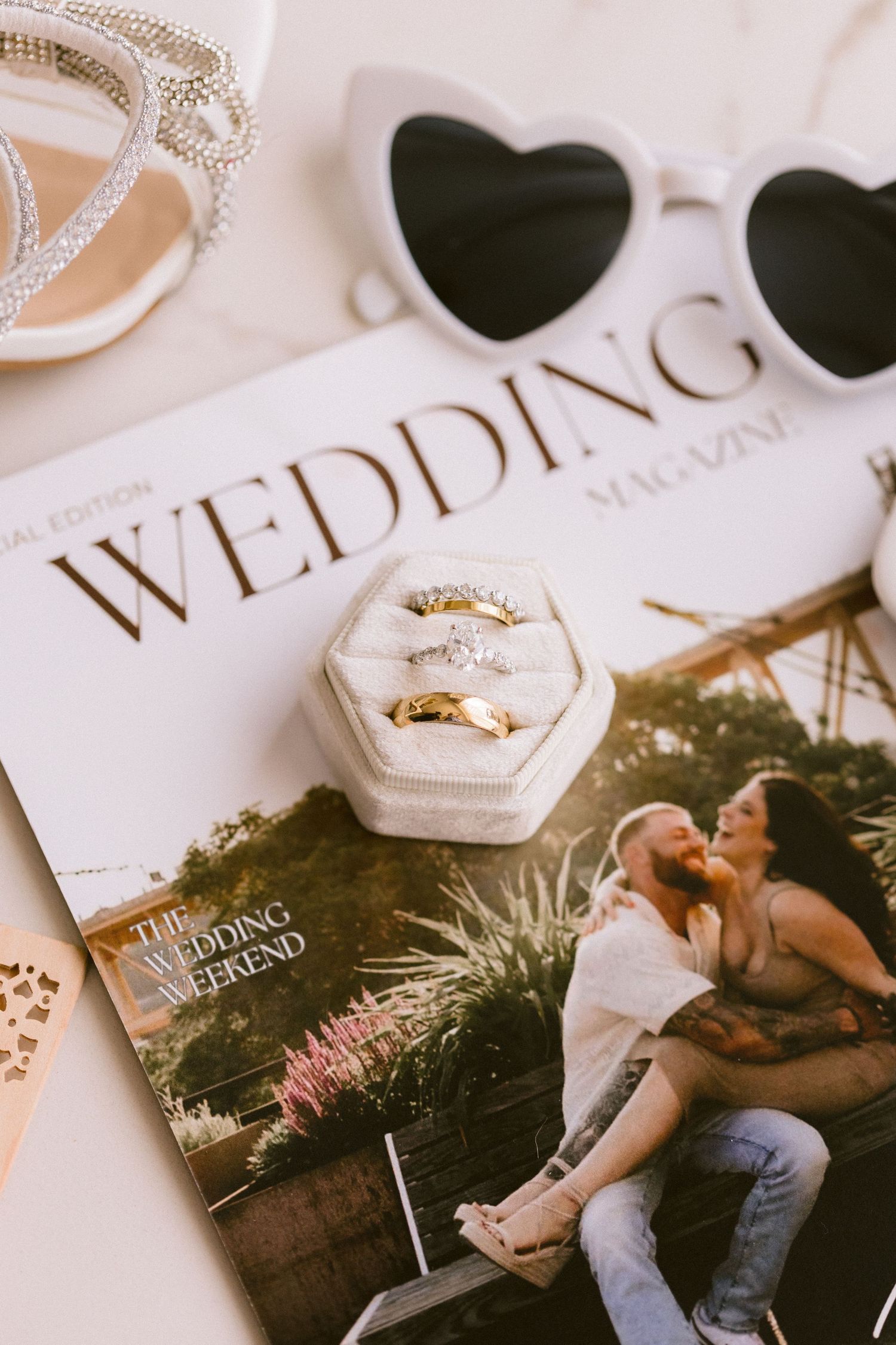 Wedding details including rings and invitations styled with elegant decorative elements.